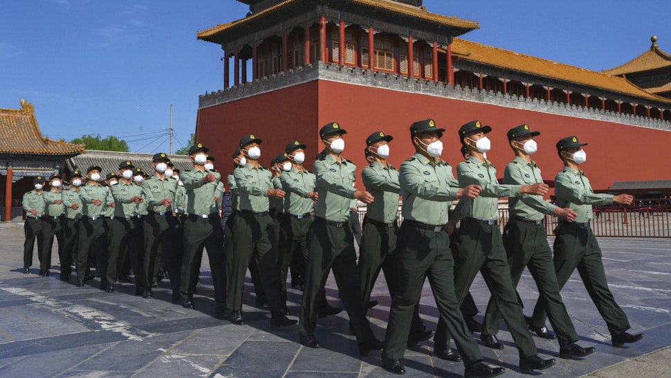 BEIJING, CHINA - MAY 20: Soldiers of the People's Liberation Army's Honour Guard Battalion march outside the Forbidden City, near Tiananmen Square, on May 20, 2020 in Beijing, China. China's government will open its annual weeklong meetings known as the 'two sessions' at the Great Hall of the People on May 21st. They were delayed in March due to the COVID-19 pandemic. After decades of growth, officials recently said China's economy had shrunk in the latest quarter due to the impact of the coronavirus epidemic. The slump in the worlds second largest economy is regarded as a sign of difficult times ahead for the global economy. While industrial sectors in China are showing signs of reviving production, a majority of private companies are operating at only 50% capacity, according to analysts. With the pandemic hitting hard across the world, officially the number of coronavirus cases in China is dwindling, ever since the government imposed sweeping measures to keep the disease from spreading. Officials believe the worst appears to be over in China, though there are concerns of another wave of infections as the government attempts to reboot the worlds second largest economy. Since January, China has recorded more than 82,000 cases of COVID-19 and at least 4000 deaths, mostly in and around the city of Wuhan, in central Hubei province, where the outbreak first started.