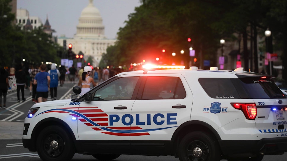 WASHINGTON, USA - MAY 29: A police car is seen as hundreds of demonstrators rally hours after the arrest of a white police officer involved in the death of a black man George Floyd in the state of Minnesota on May 29, 2020 in Washington D.C. United States. Floyd, 46, a black man, was arrested Monday after reportedly attempting to use a counterfeit $20 bill at a local store. Video footage on Facebook showed him handcuffed and cooperating. But police claimed he resisted arrest. A white officer kneeled on his neck, despite Floydâs repeated pleas of I can't breathe. Former police officer Derek Chauvin was charged with third-degree murder and manslaughter, according to Hennepin County Prosecutor Michael Freeman. Minneapolis, Minnesota Mayor Jacob Frey said Friday he imposed a mandatory curfew because of ongoing protests regarding the death of George Floyd. Protestors made their way to the White House where they faced a police response with some clashing with the secret service members.