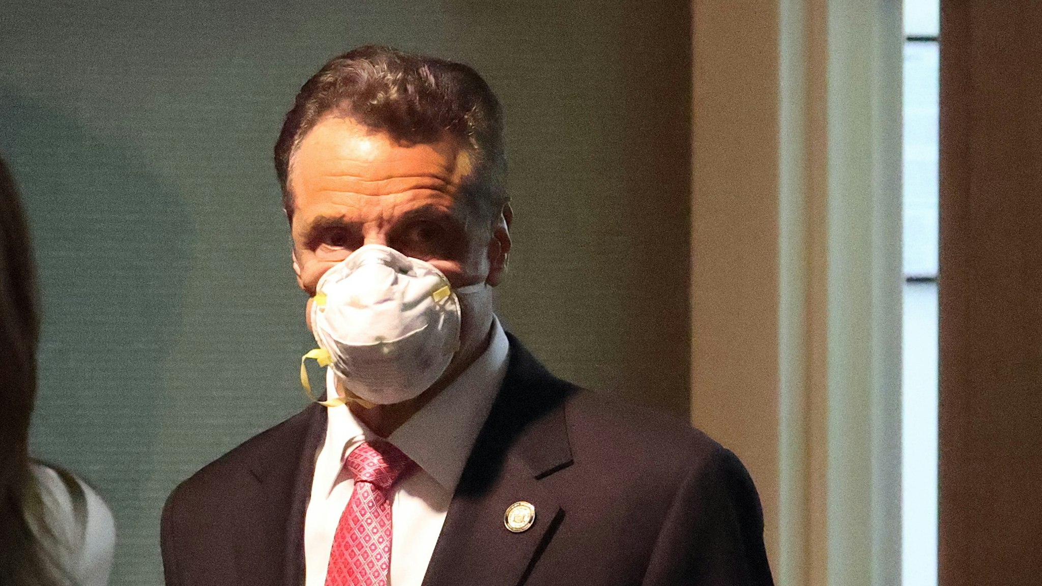 MANHASSET, NEW YORK - MAY 06: New York Governor Andrew Cuomo enters the room wearing a mask prior to speaking during a Coronavirus Briefing At Northwell Feinstein Institute For Medical Research on May 06, 2020 in Manhasset, New York. (Photo by
