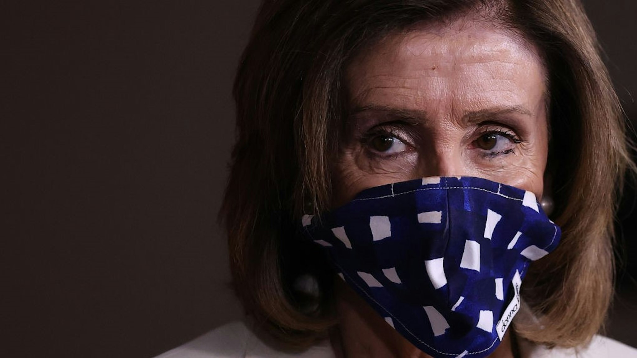 WASHINGTON, DC - APRIL 30: Speaker of the House Nancy Pelosi (D-CA) wears a cloth mask to cover her mouth and nose to prevent the spread of the novel coronavirus during her weekly news conference at the U.S. Capitol April 30, 2020 in Washington, DC. While she and Democratic House leaders are not going to reconvene next week due to the COVID-19 pandemic, she said committee chairs are working on the next piece of economic rescue legislation. (Photo b