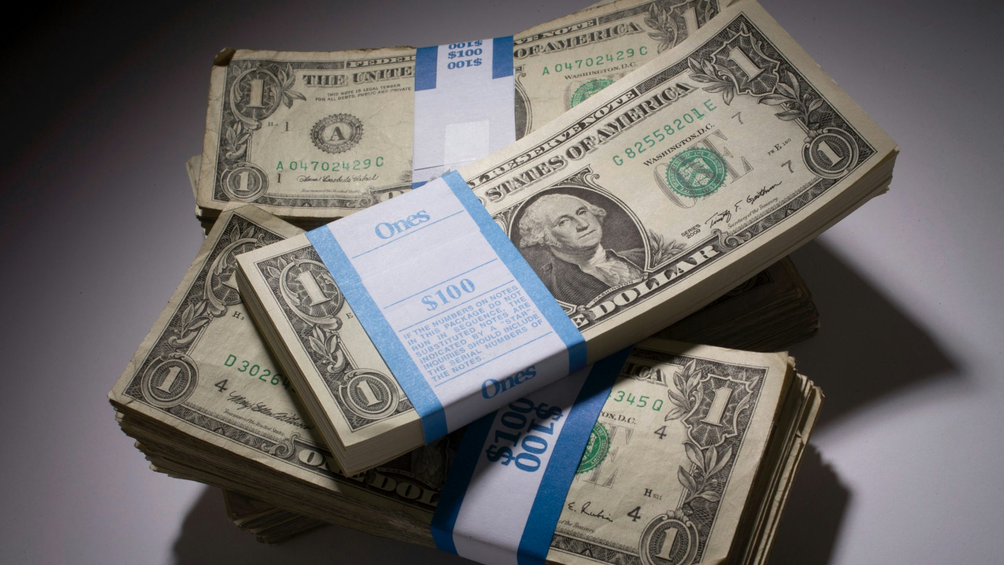 Stacks of U.S. one-dollar bills are arranged for a photograph in New York, U.S., on Monday, Feb. 4, 2013.