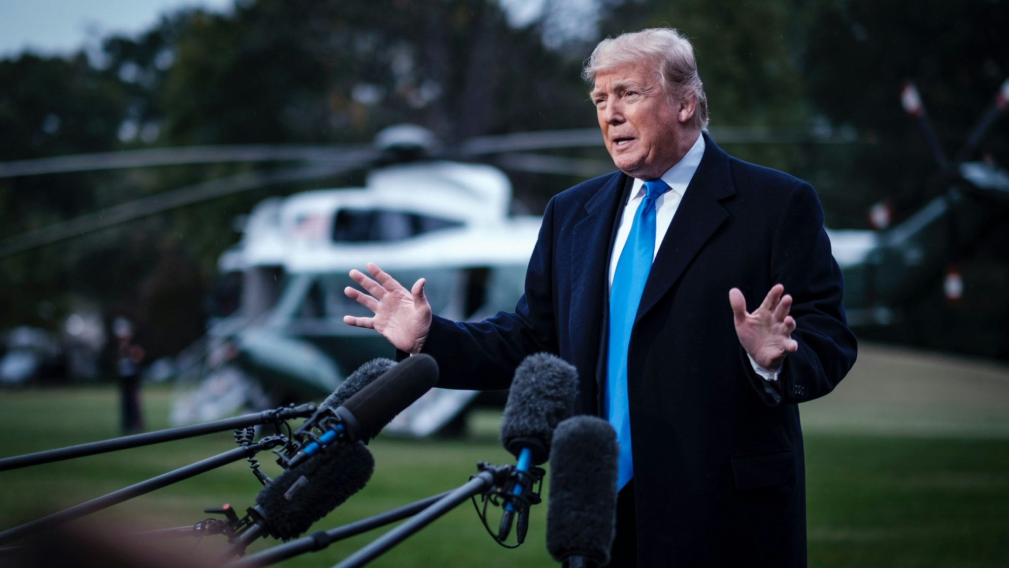 US President Donald Trump speaks to the media as he prepares to board Marine One on the South Lawn of the White House on October 26, 2018 in Washington, DC. Trump was traveling to a rally in Charlotte, NC.