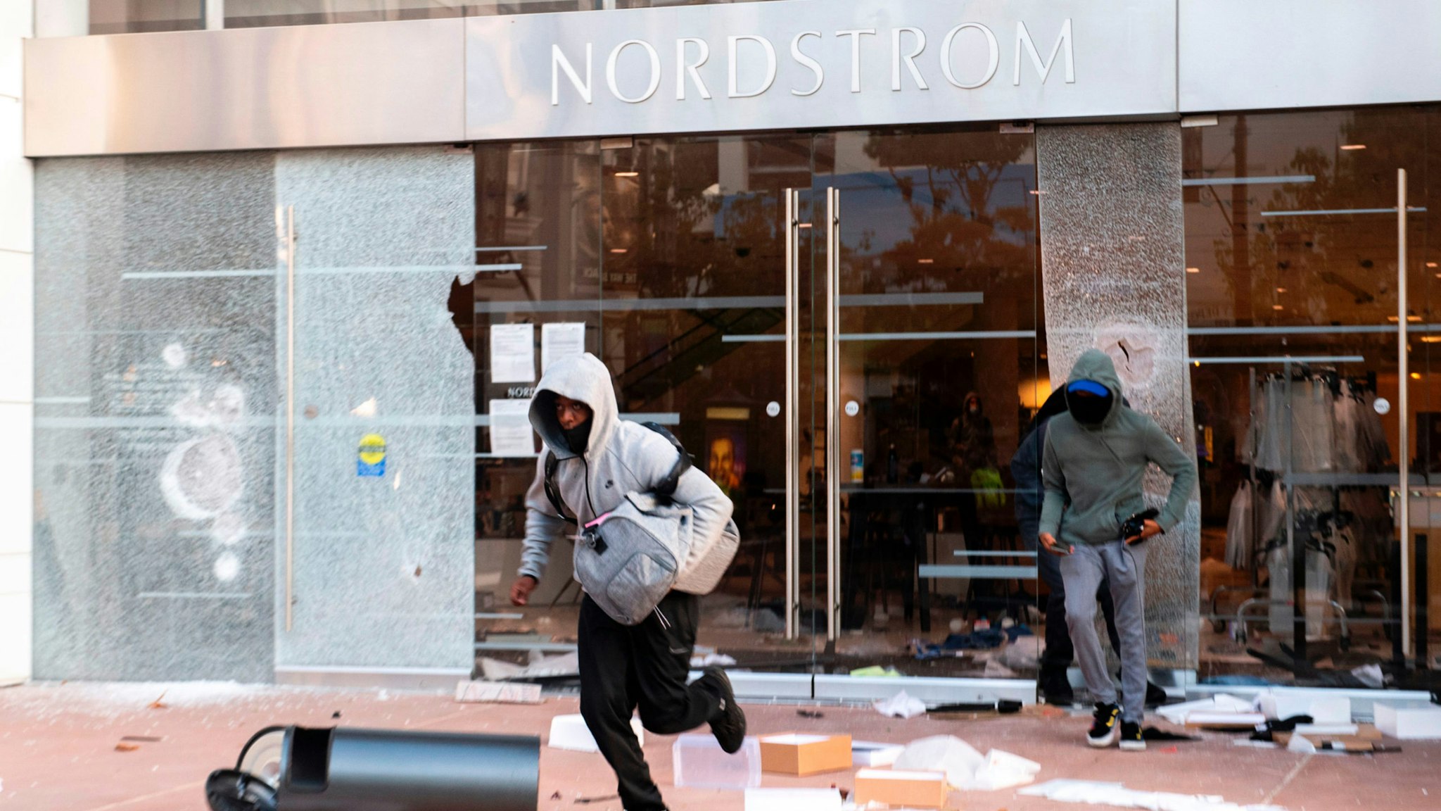 People are seen looting stores at the Grove shopping center in the Fairfax District of Los Angeles on May 30, 2020 following a protest against the death of George Floyd, an unarmed black man who died while while being arrested and pinned to the ground by the knee of a Minneapolis police officer.