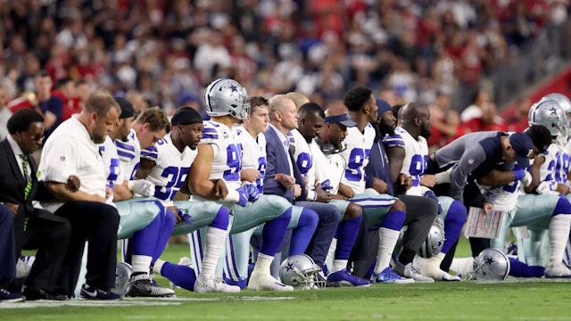 Members of the Dallas Cowboys link arms and kneel during the National Anthem before the start of the NFL game against the Arizona Cardinals at the University of Phoenix Stadium on September 25, 2017 in Glendale, Arizona. (Photo by Christian Petersen/Getty Images)