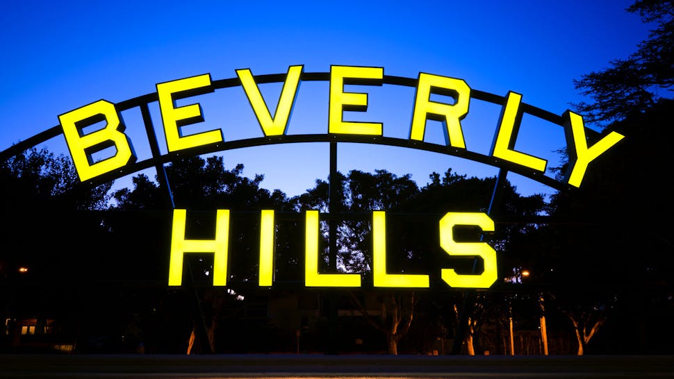 A lit up Beverly Hills sign at night Beverly Hills sign located along Santa Monica Boulevard in Beverly Hills, CA at night.