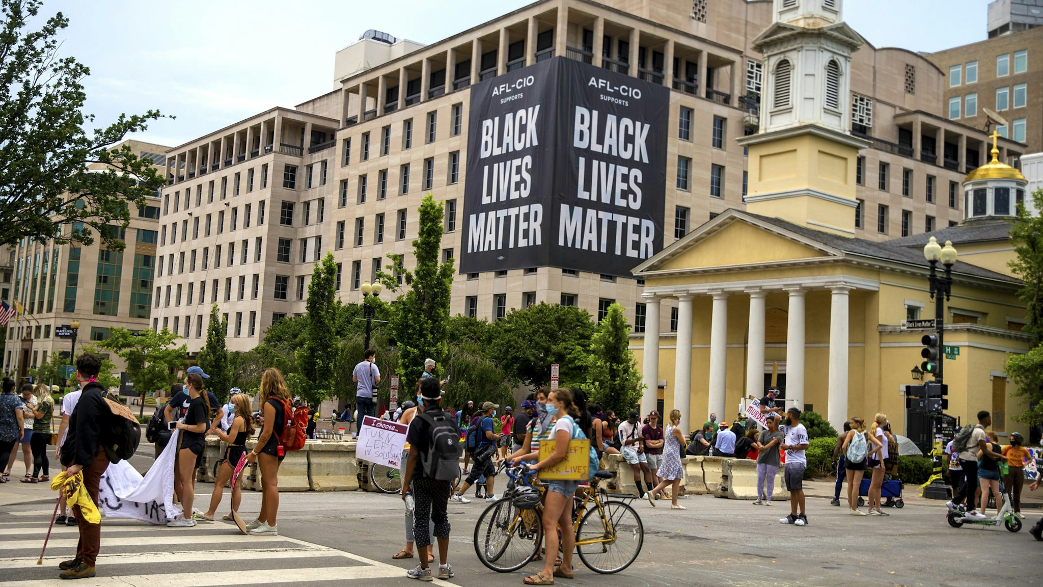 WASHINGTON, DC - JUNE 22: Protesters move items they found to block off police after the police tried to open up H Street to traffic on June 22, 2020 in Washington, DC. Protests continue around the country over the deaths of African Americans while in police custody.