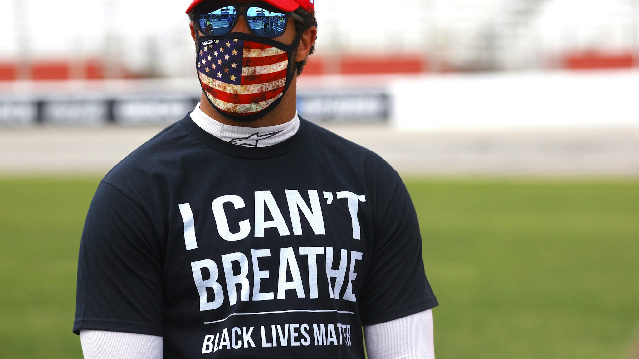 HAMPTON, GEORGIA - JUNE 07: Bubba Wallace, driver of the #43 McDonald's Chevrolet, wears a "I Can't Breathe - Black Lives Matter" T-shirt under his fire suit in solidarity with protesters around the world taking to the streets after the death of George Floyd on May 25 while in the custody of Minneapolis, Minnesota police stands on the grid prior to the NASCAR Cup Series Folds of Honor QuikTrip 500 at Atlanta Motor Speedway on June 07, 2020 in Hampton, Georgia.