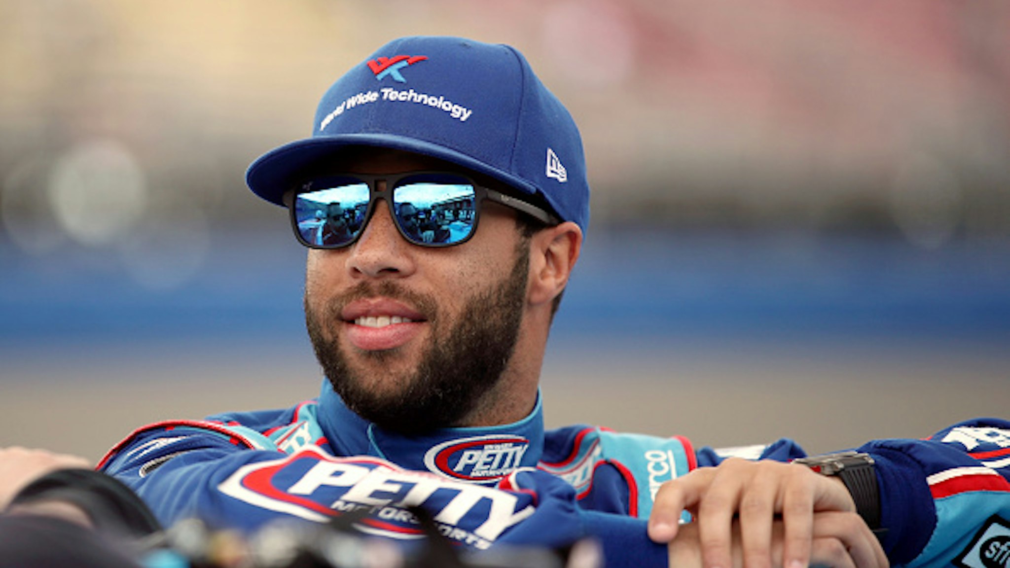 FONTANA, CALIFORNIA - FEBRUARY 29: Bubba Wallace, driver of the #43 Victory Junction Chevrolet, stands by his car before qualifying for the NASCAR Cup Series Auto Club 400 at Auto Club Speedway on February 29, 2020 in Fontana, California.