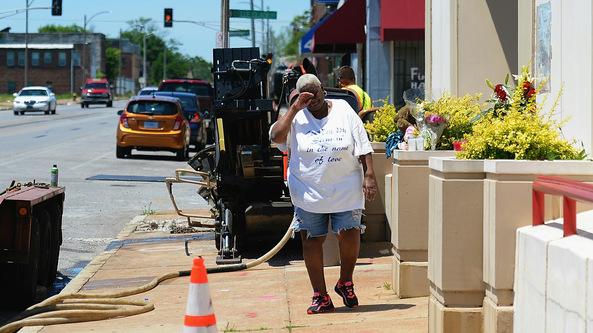 ST LOUIS, MO - JUNE 2: Diane Davis of St. Louis stops to leave flowers and pay respects to David Dorn, a 77-year-old retired police captain who was murdered during overnight rioting outside Lee's Pawn and Jewelry, on June 2, 2020 in St Louis, Missouri. Four police officers were reportedly shot in St. Louis overnight during violent clashes with protesters leading to looting and damage to local businesses.