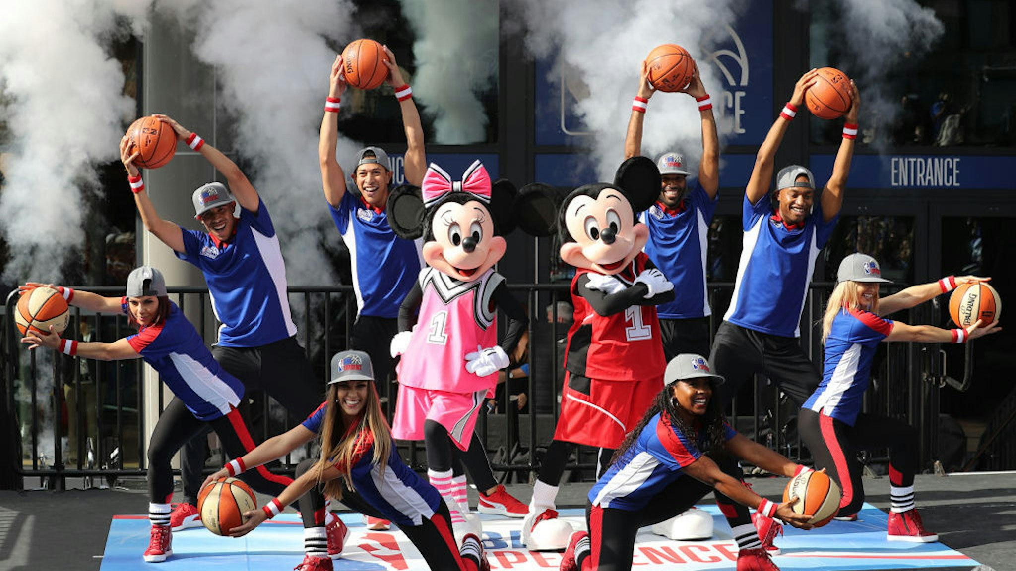 Mickey Mouse and Minnie with dancers during the opening day for NBA Experience, a basketball-driven interactive attraction at Disney Springs in Orlando, Fla., on August 12, 2019. (Ricardo Ramirez Buxeda/Orlando Sentinel/TNS)
