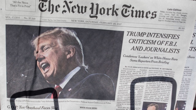 The front page of the New York Times carries a picture of President Donald Trump February 25, 2017 a day after he criticized in a speech the FBI and journalists in New York City. Certain media outlets were barred from attending a press briefing at the White House then day before. (Photo by Robert Nickelsberg/Getty Images)