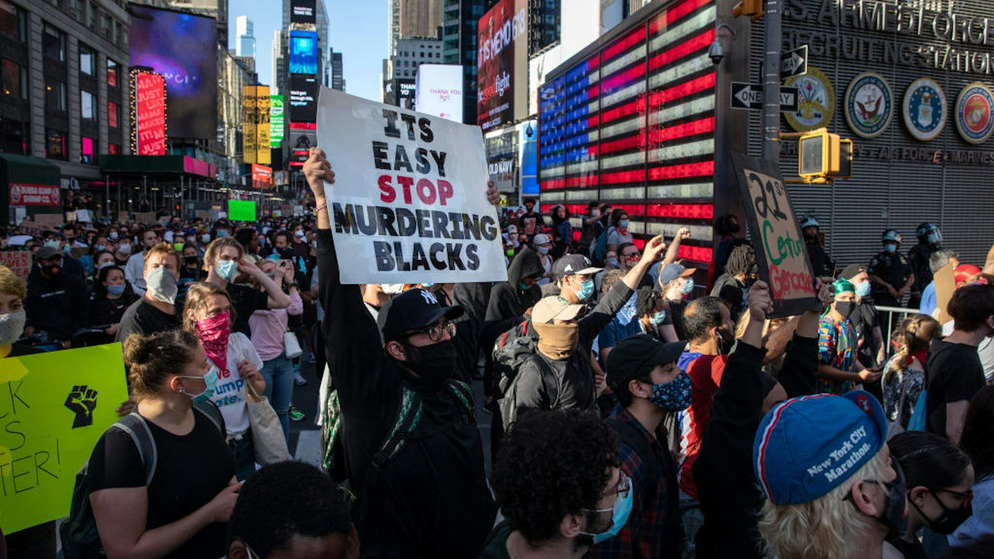 Black Lives Matter protesters kneel in Times Square during a march to honor George Floyd in Midtown Manhattan on May 31, 2020 in New York City. Protesters demonstrated for the fourth straight night after video emerged of a Minneapolis police officer, Derek Chauvin, pinning George Floyd's neck to the ground. Floyd was later pronounced dead while in police custody after being transported to Hennepin County Medical Center. The four officers involved have been fired and Chauvin has been arrested and charged with 3rd degree murder. (Photo by John Moore/Getty Images)