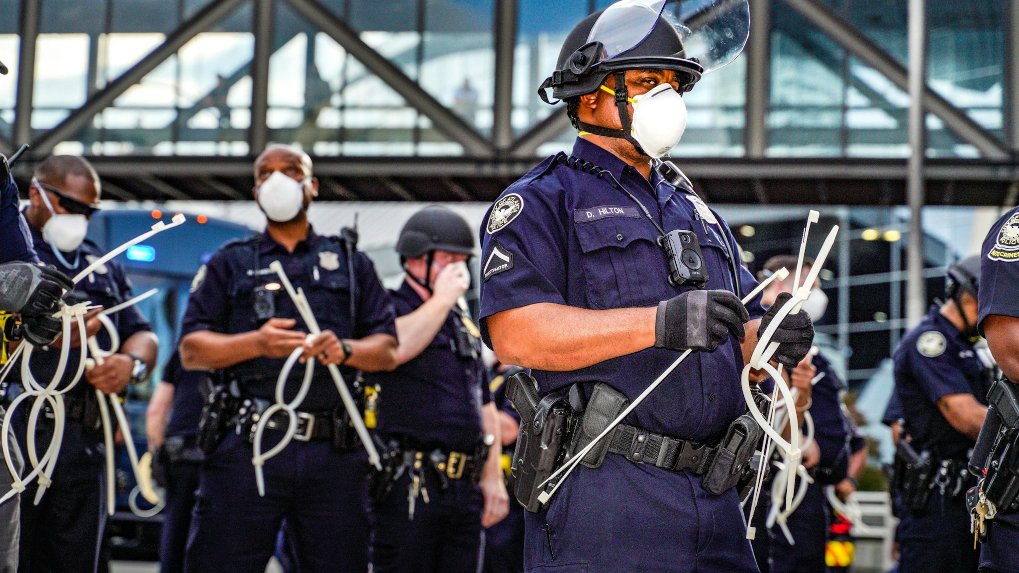 ATLANTA, USA - MAY 29: Police officers stand guard during a protest following the death of George Floyd outside of the CNN Center next to Centennial Olympic Park in downtown Atlanta, Georgia, United States on May 29, 2020. It was announced Friday that Derek Chauvin, the former Minneapolis police officer caught on camera with his knee on Floydâs neck, has been arrested and charged with third-degree murder and manslaughter.