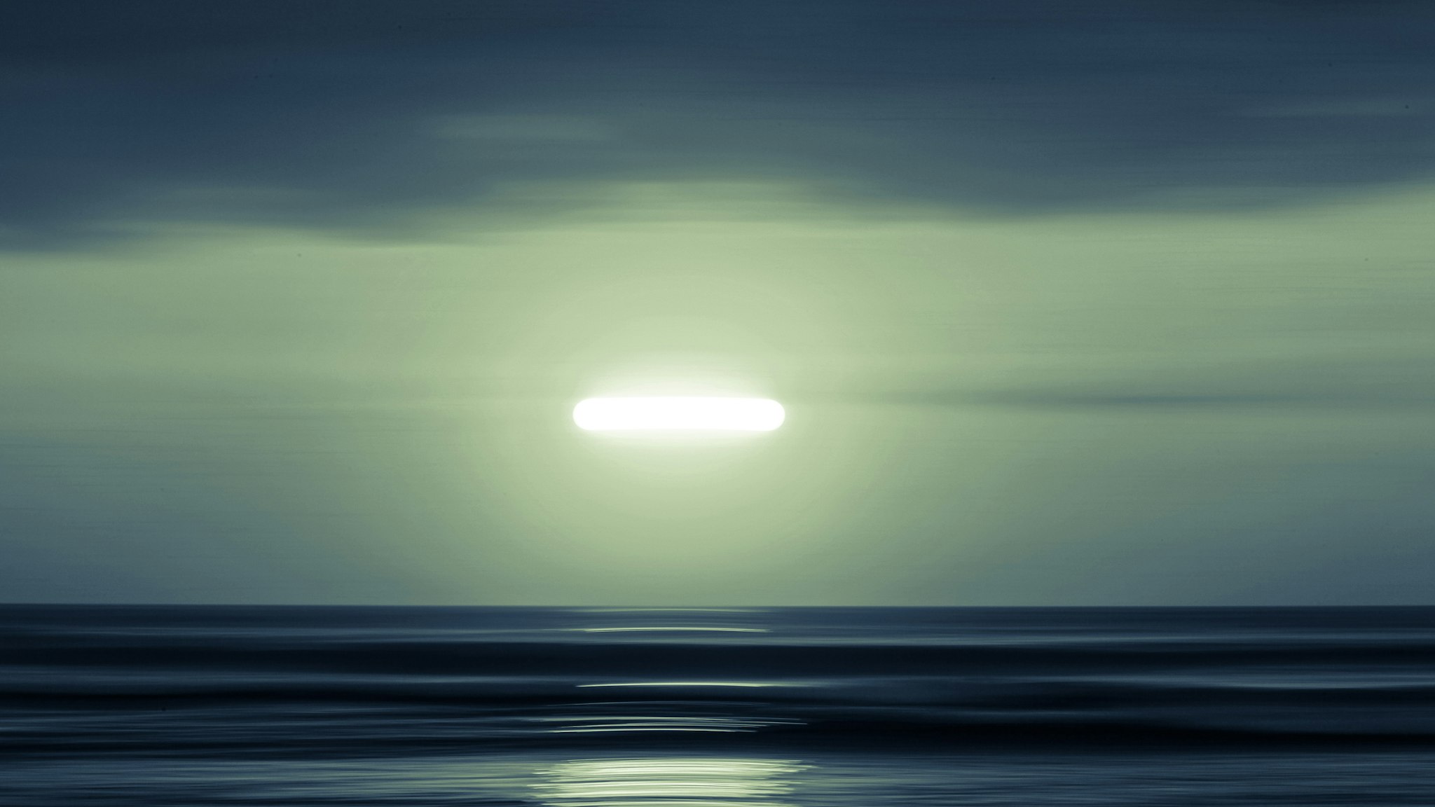 An abstract image of the moon over the ocean in South America.
