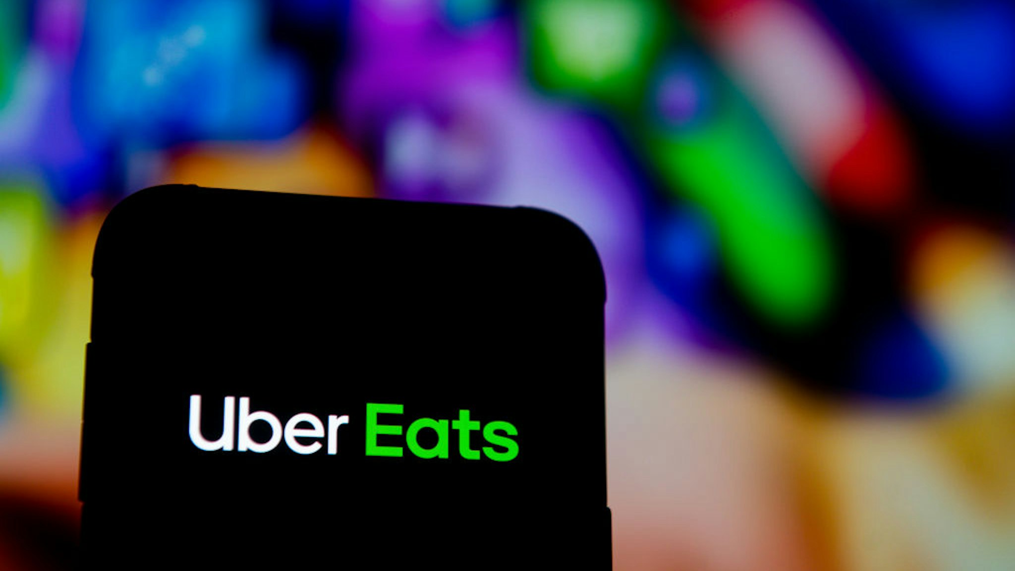 In this photo illustration an Uber Eats logo seen displayed on a smartphone.
