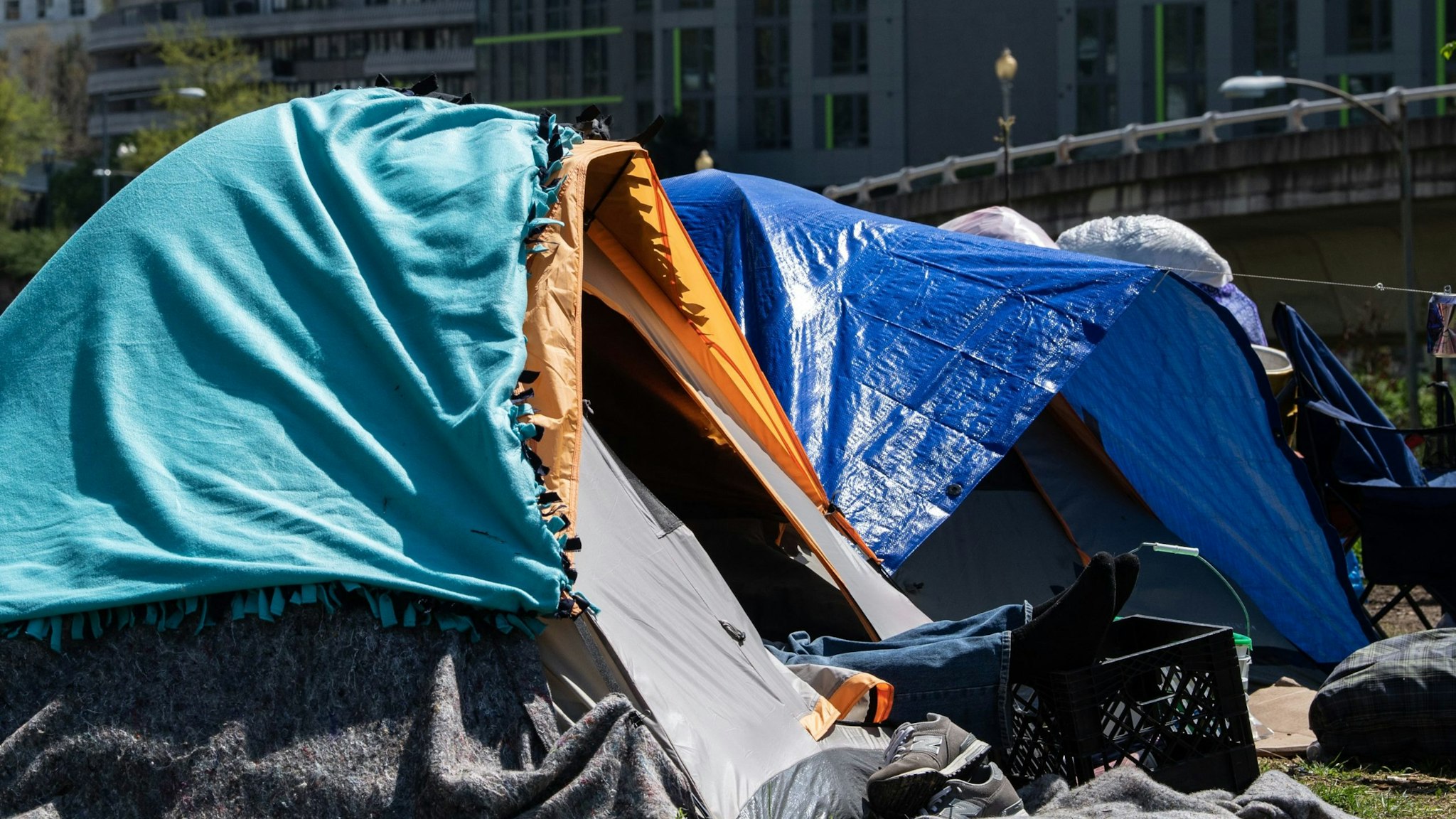 A homeless man rests in a tent in an encampment of homeless people in Washington, DC, on April 8, 2020. - The COVID-19 death toll in the US leapt to more than 15,000 Thursday, according to a running tally by Johns Hopkins University, from well over 400,000 confirmed cases.Meanwhile unemployment is rising at a jarring rate, with data Thursday showing 17 million have lost their jobs since mid-March, when America began shutting down. (Photo by NICHOLAS KAMM / AFP) (Photo by NICHOLAS KAMM/AFP via Getty Images)