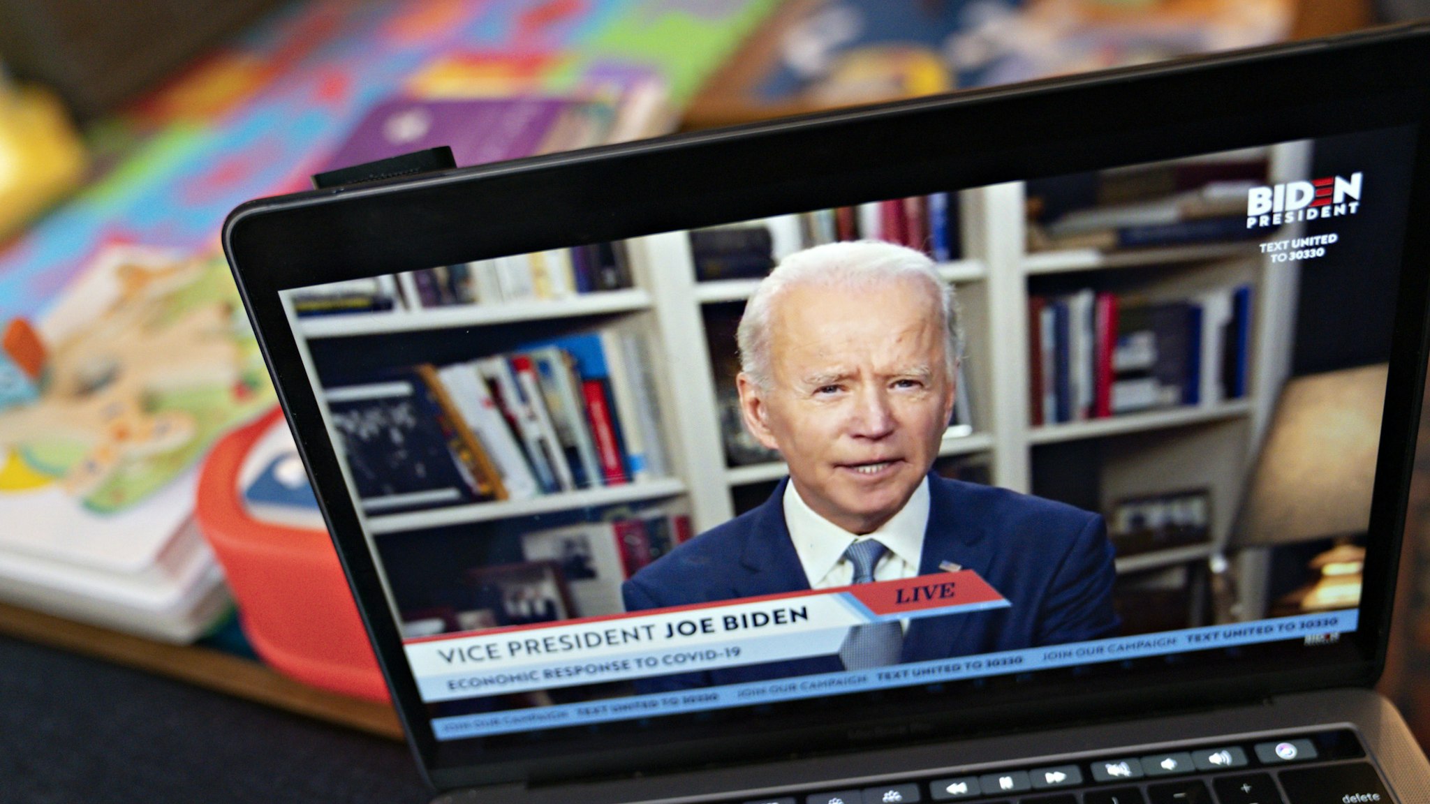 Former Vice President Joe Biden, presumptive Democratic presidential nominee, speaks during a virtual event seen on an Apple Inc. laptop computer in Arlington, Virginia, U.S., on Monday, April 13, 2020. Senator Bernie Sanders endorsed Biden during the joint livestream saying that Americans of all political affiliations should back the former vice president. Photographer: Andrew Harrer/Bloomberg via Getty Images