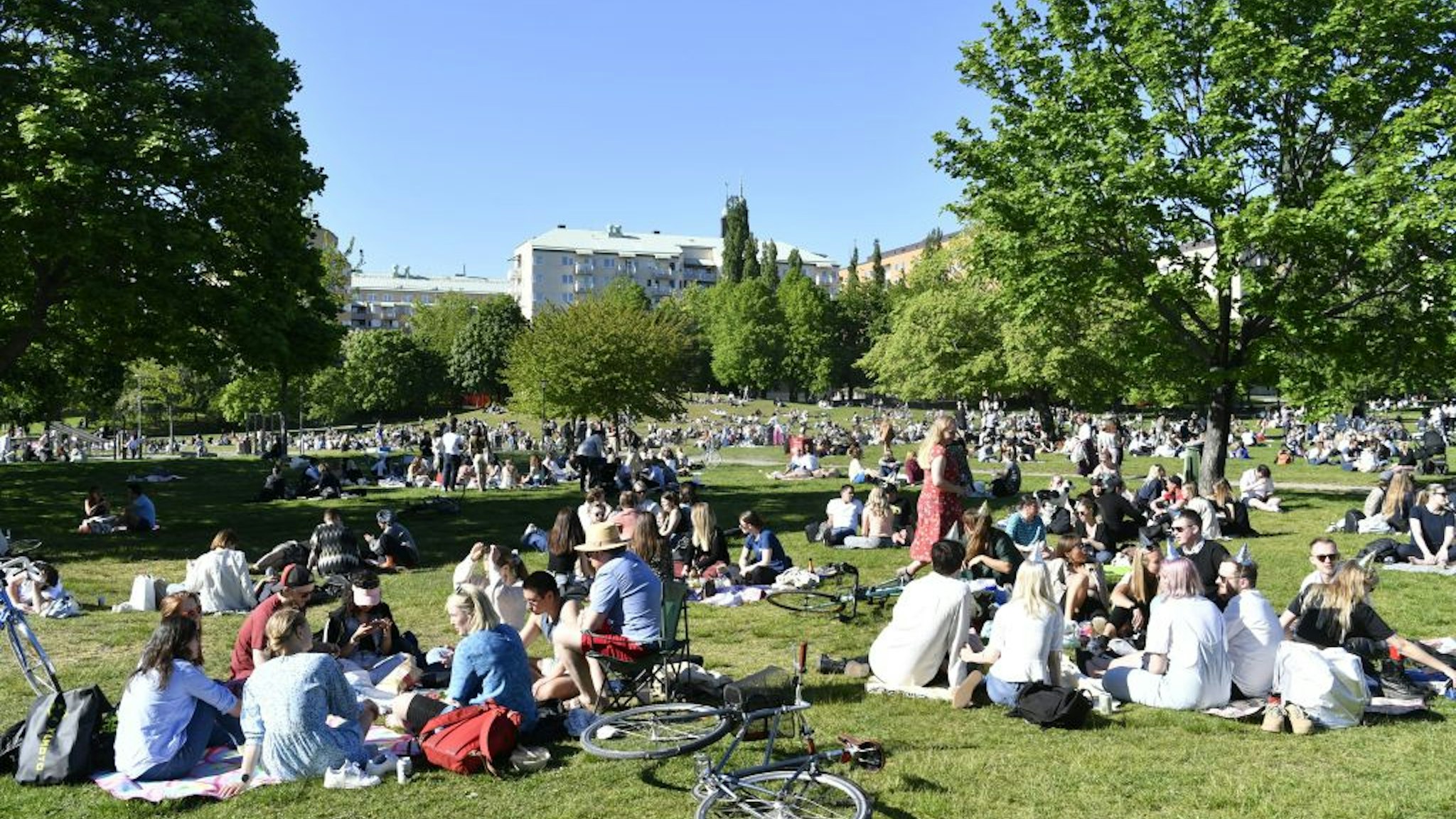 People enjoy the sunny weather in Tantolunden park in Stockholm on May 30, 2020, amid the novel coronavirus pandemic.