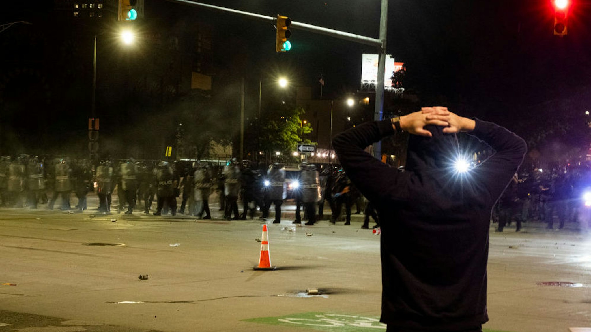 Police officers hold a line during a night of clashes between protesters and Detroit Police Officers, violence returned to downtown Detroit as police made dozens of arrests and fired tear gas and rubber bullets at protesters on May 30, 2020 in Detroit, Michigan.