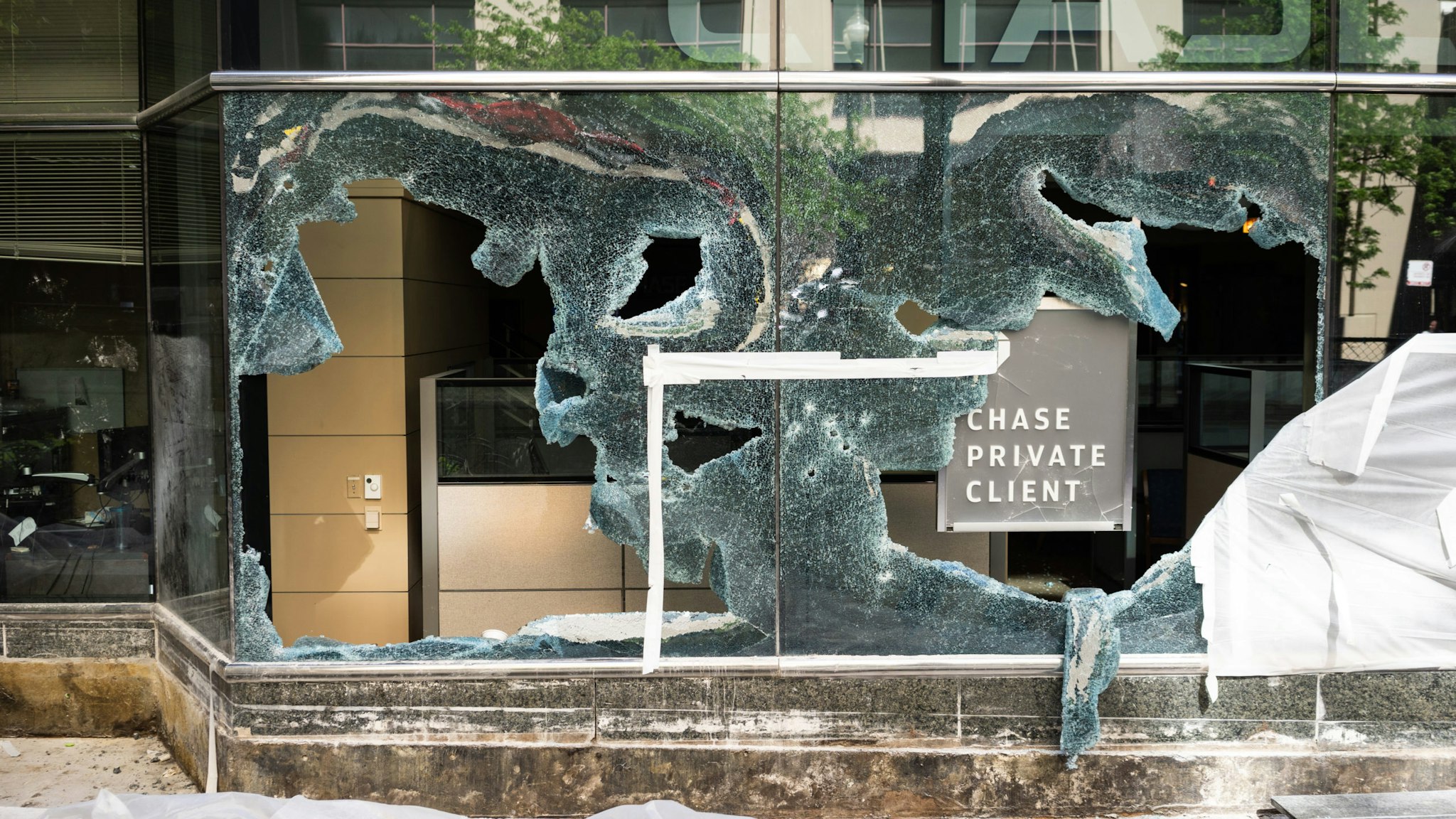 The windows of a Chase Bank are seen shattered in Downtown Chicago on May 31, 2020. On Saturday, thousands of demonstrators in Chicago protested the killing of George Floyd by Minneapolis Police. By the evening, looting and destruction of property spread throughout the city center. (Photo by Max Herman/NurPhoto via Getty Images)