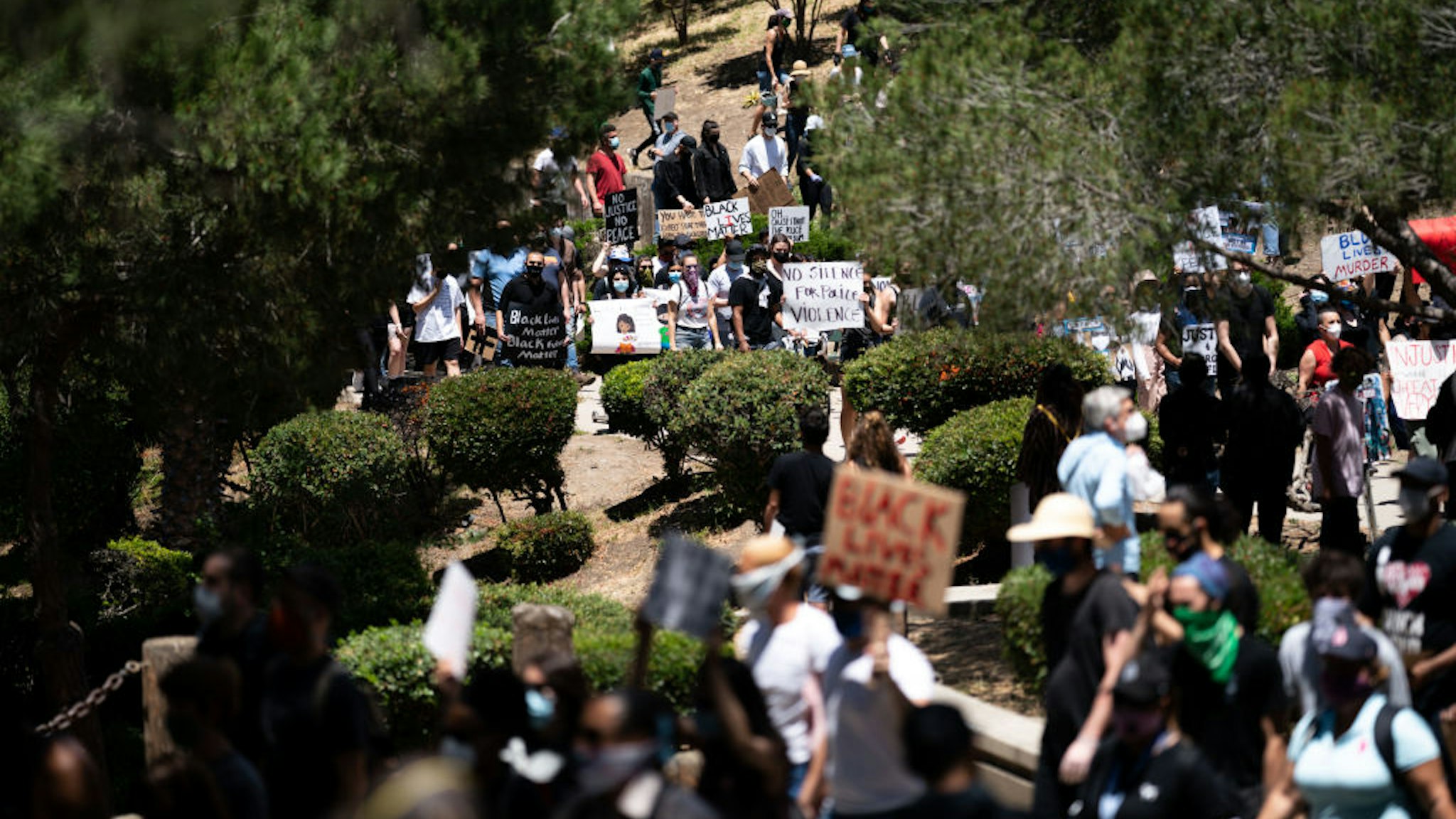 People at a gathering setup by groups Black Lives Matter Los Angeles and Build Power that started at Pan Pacific Park and went through the Fairfax District on Saturday, May 30, 2020 in Los Angeles, CA.