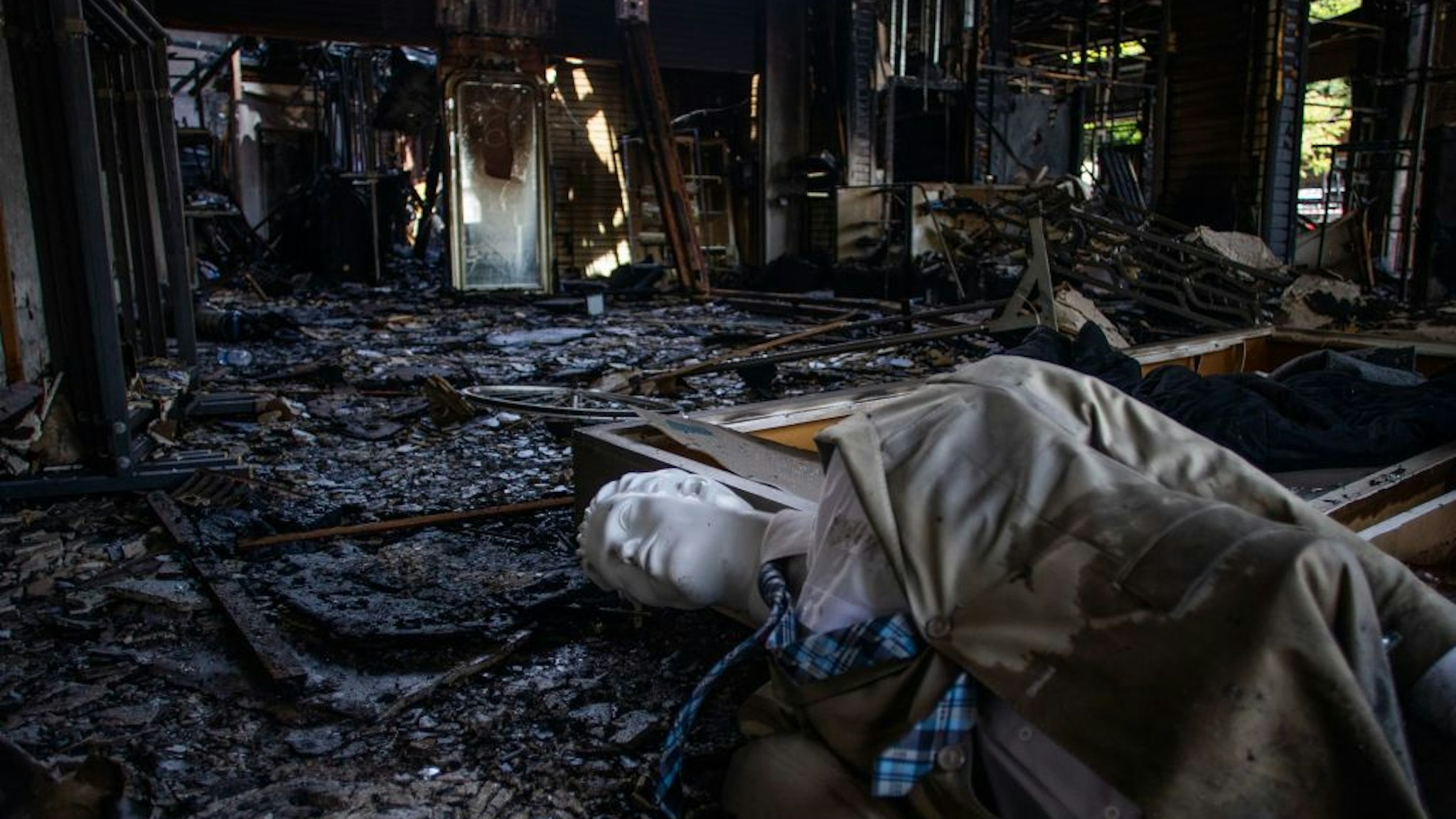 mannequin is seen on the floor of a burned commercial building in Downtown Long Beach, California on Jun