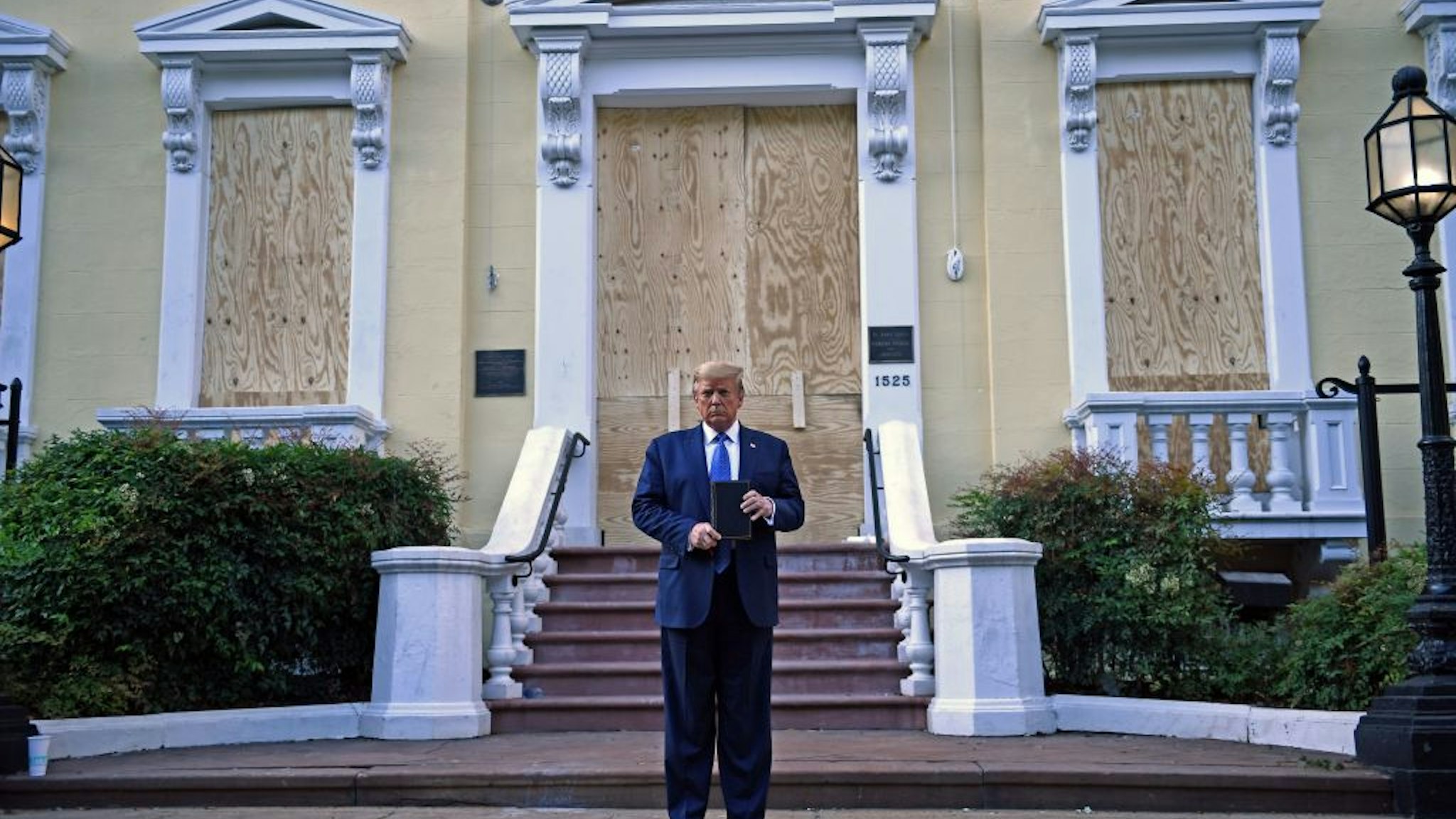 US President Donald Trump holds up a Bible outside of St John's Episcopal church across Lafayette Park in Washington, DC on June 1, 2020.