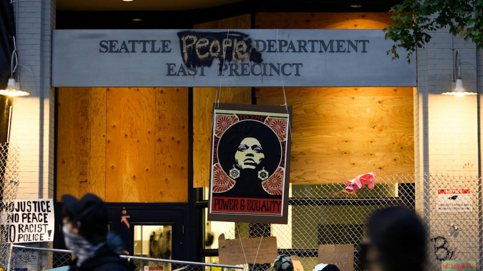 An image of activist Angela Davis is displayed above the entrance to the Seattle Police Department's East Precinct, vacated June 8, and now surrounded by streets reopened to pedestrians forming an area named the Capitol Hill Autonomous Zone (CHAZ) in Seattle, Washington on June 12, 2020.