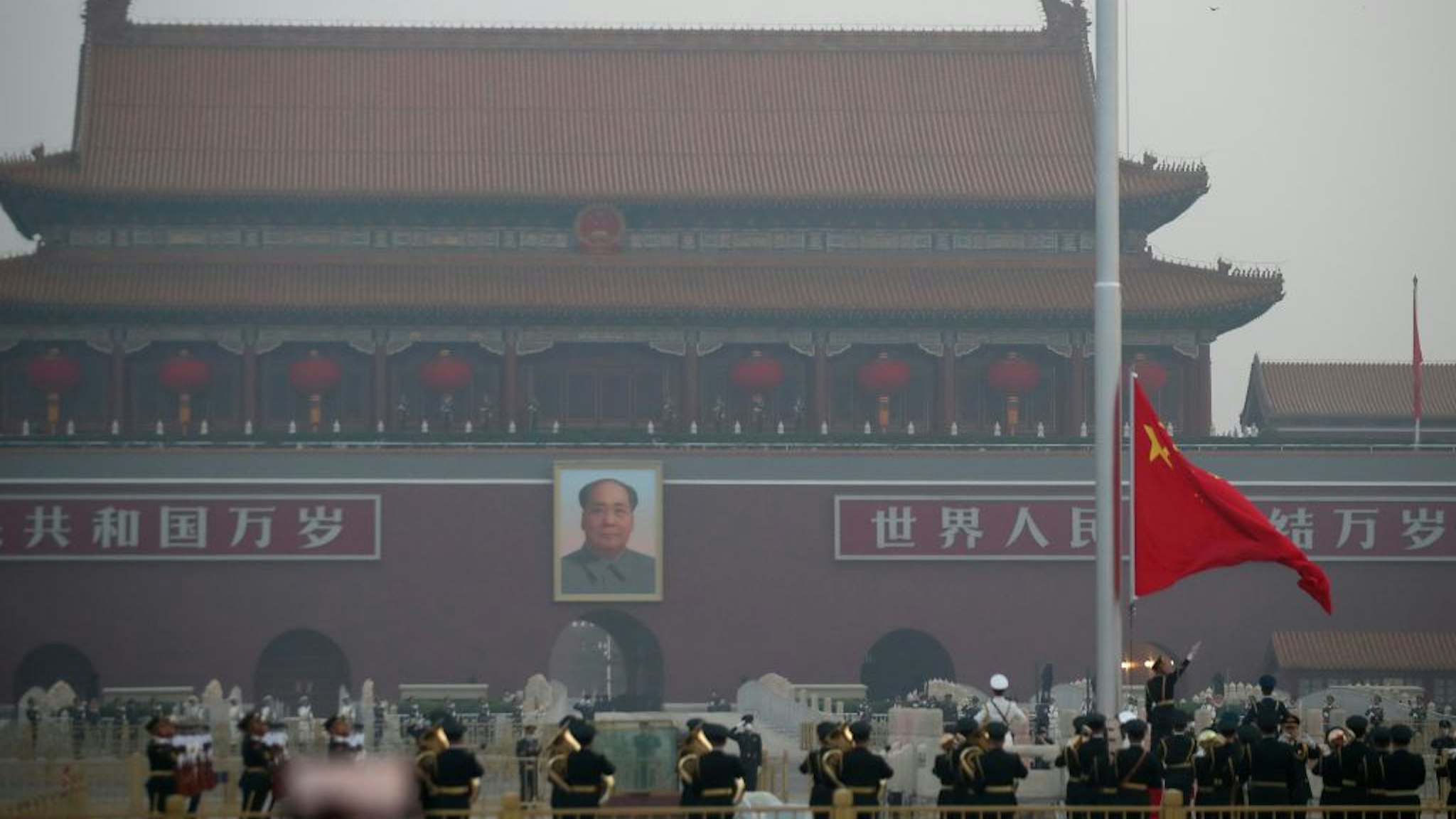 Chinese People's Liberation Army (PLA) officers attend the flag-raising ceremony at Tiananmen Square on the International Workers' Day on May 1, 2020 in Beijing, China.