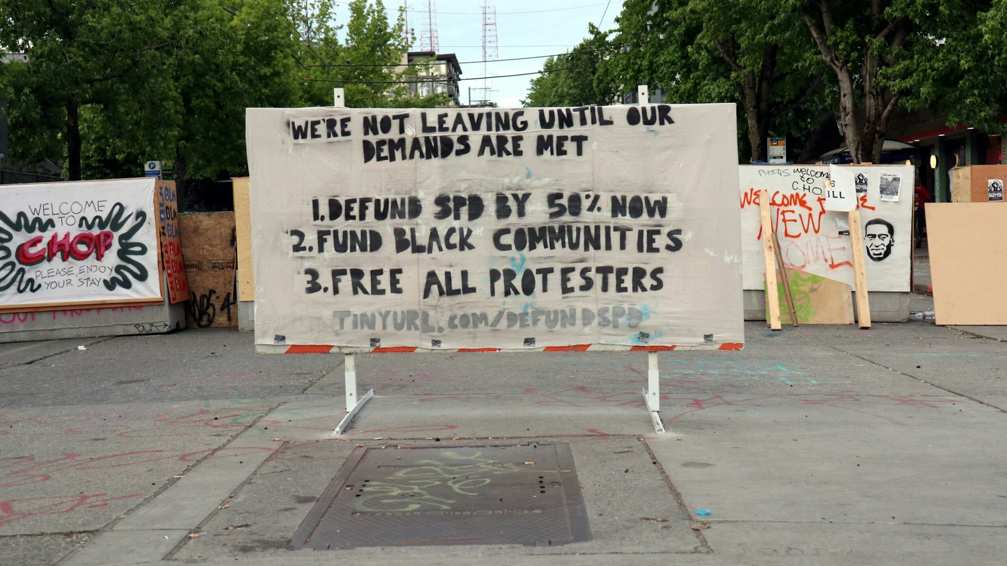SEATTLE, WASHINGTON, UNITED STATES - 2020/06/23: A placard seen outside the western wall of Seattle's Capitol Hill Occupied Protest (CHOP) zone lists protester demands. Facing increasing pressure from residents and business owners, Mayor Jenny Durkan on Monday vowed to retake the police station she previously ordered surrendered. (Photo by Toby Scott/SOPA Images/LightRocket via Getty Images)