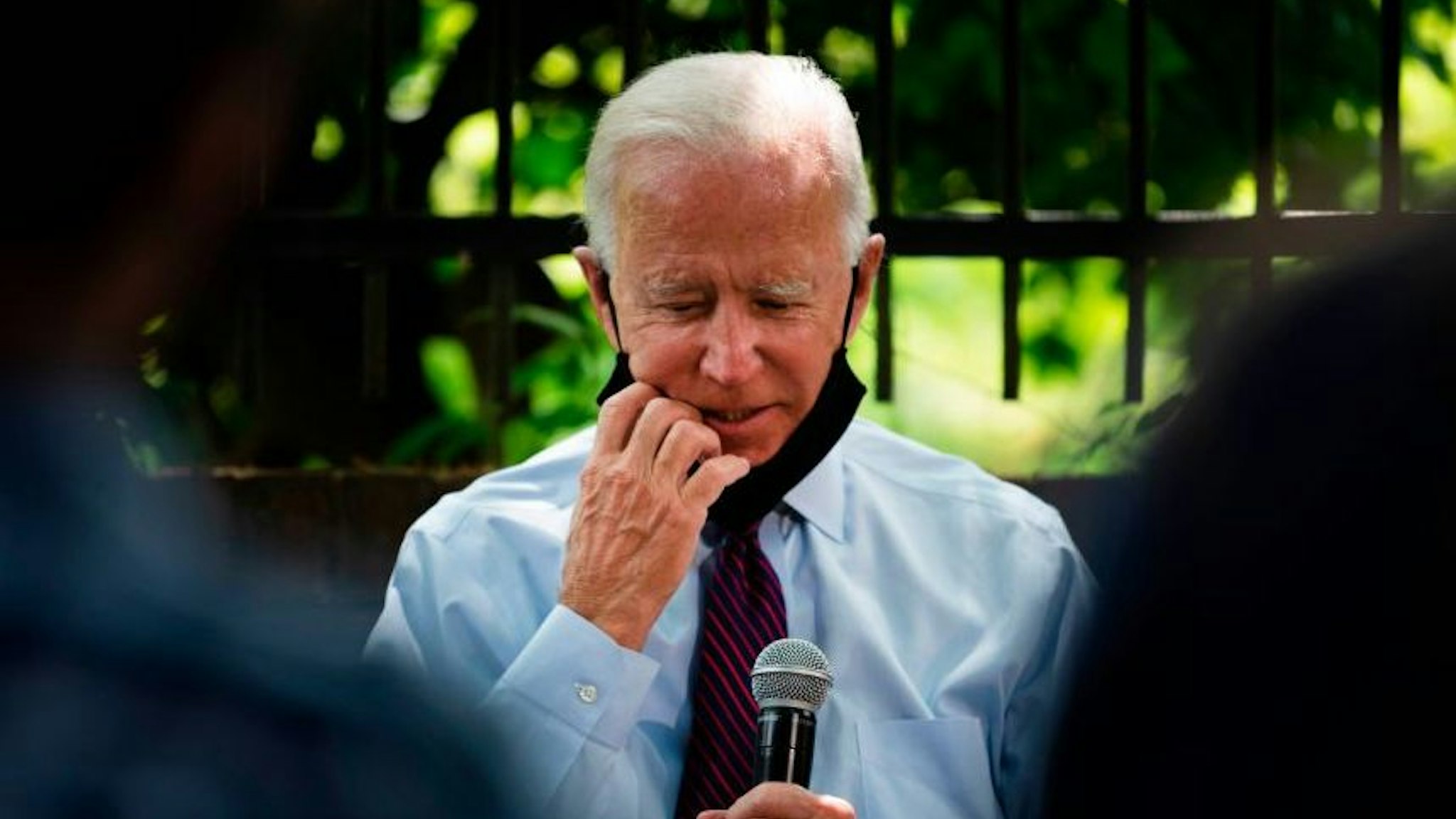 Democratic presidential candidate Joe Biden adjusts his facemask as he meets with Pennsylvania families who have benefited from the Affordable Care Act on June 25, 2020 in Lancaster, Pennsylvania.