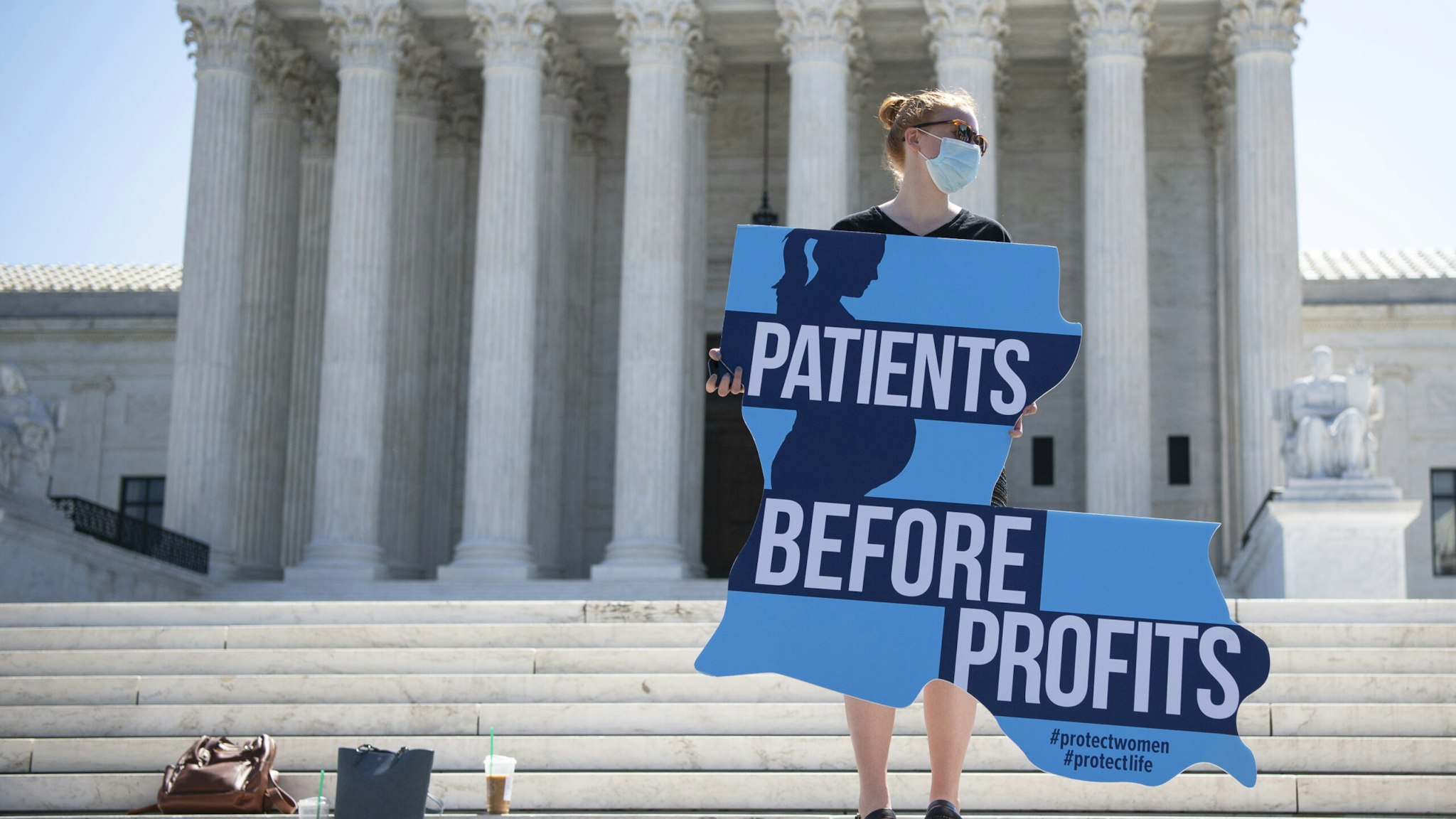 UNITED STATES - JUNE 29: An anti-abortion demonstrator holds a sign as she and others protest in front of the Supreme Court after a decision was made to strike down a Louisiana law regulating abortion clinics in Washington on Monday, June 29, 2020. (Photo by Caroline Brehman/CQ-Roll Call, Inc via Getty Images)