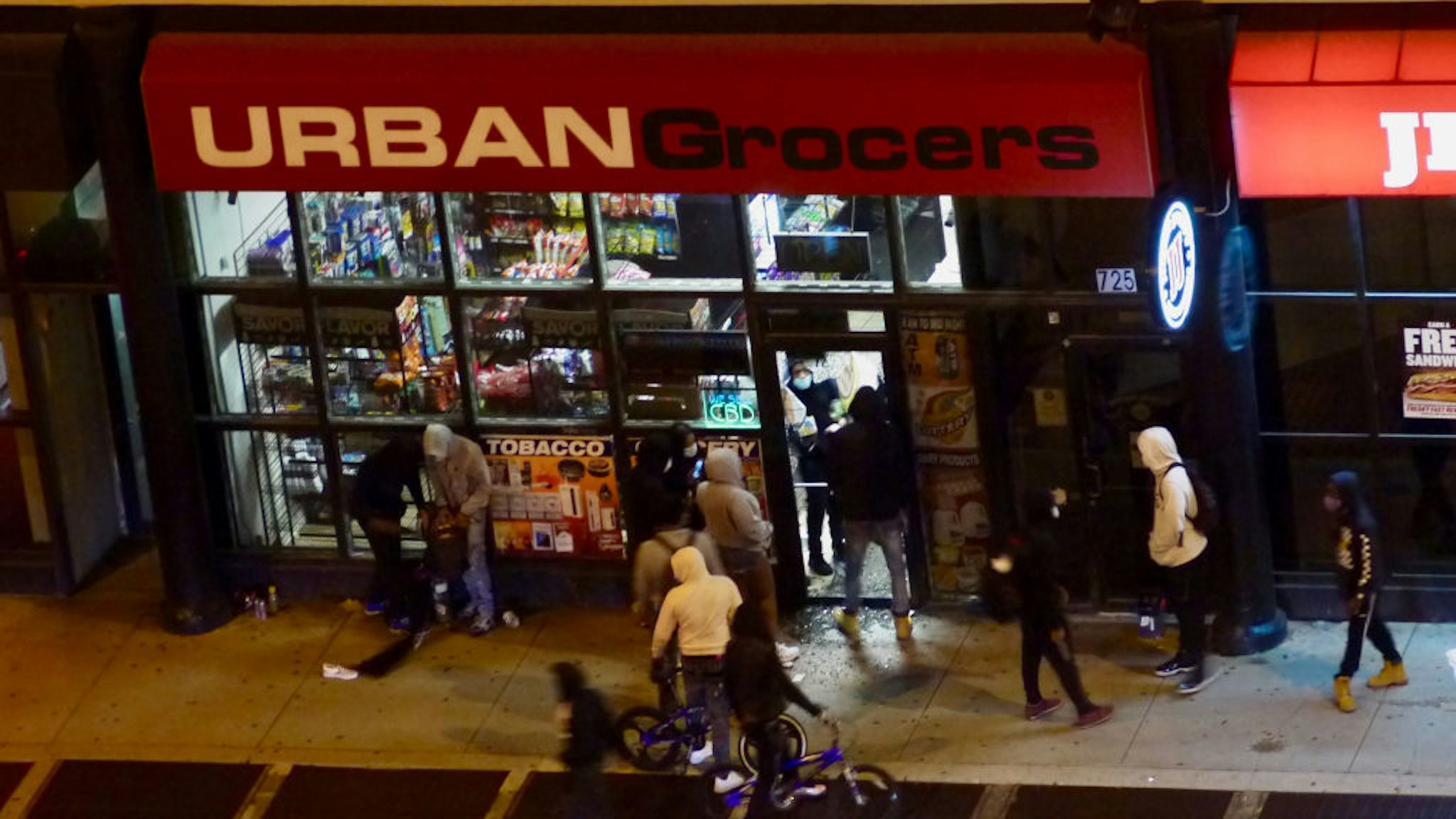 Looters enter a store during protests against the death of George Floyd, in the South Loop of Chicago, Illinois, May 31, 2020.