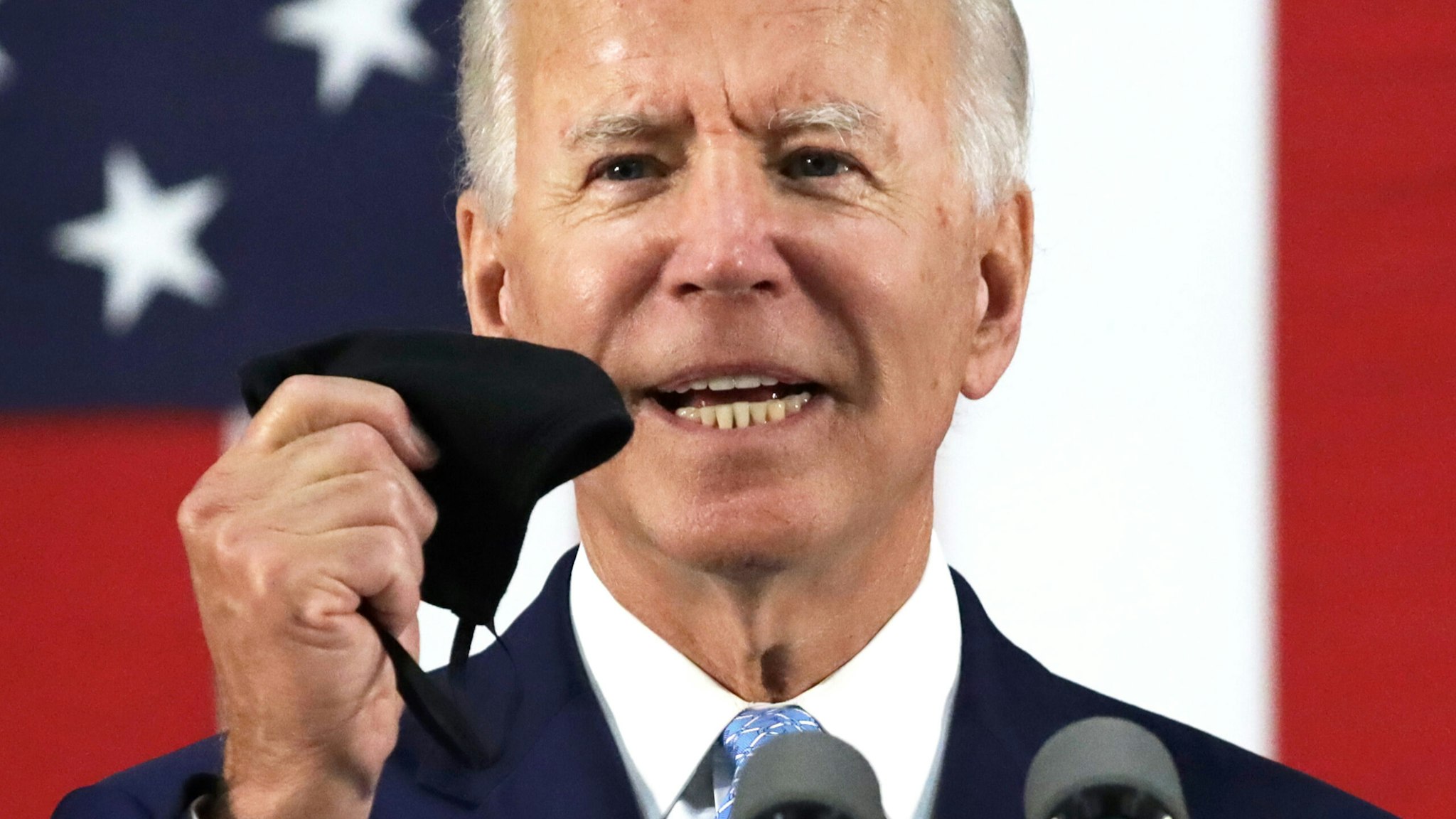 WILMINGTON, DELAWARE - JUNE 30: Democratic presidential candidate, former Vice President Joe Biden holds up a mask as he speaks during a campaign event June 30, 2020 at Alexis I. Dupont High School in Wilmington, Delaware. Biden discussed the Trump Administration’s handling of the COVID-19 pandemic. (Photo by Alex Wong/Getty Images)