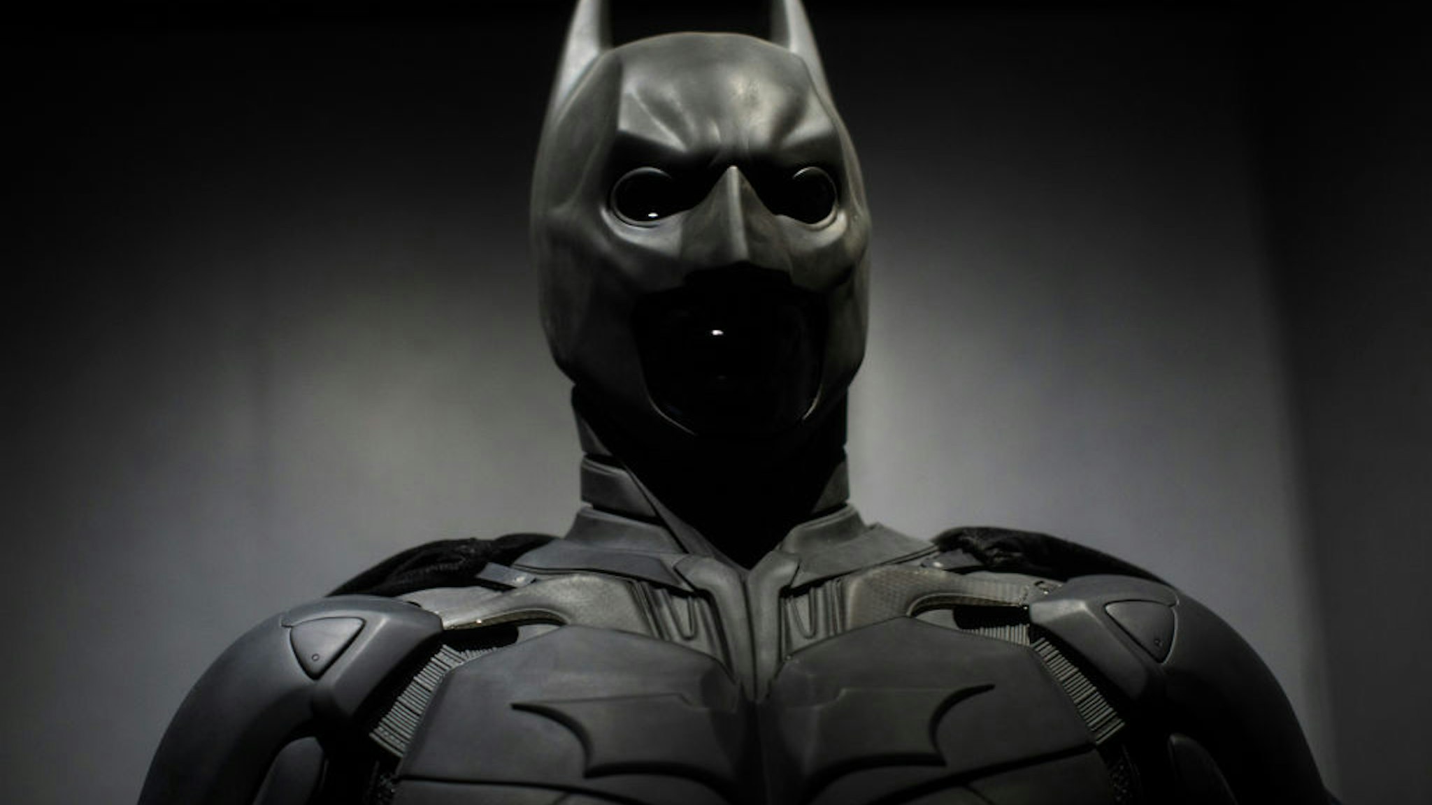 A Batman costume from the 2012 Dark Knight Rises film worn by Christian Bale and designed by Lindy Hemming is on display at the DC Comics Exhibition: Dawn Of Super Heroes at the O2 Arena on February 22, 2018 in London, England.