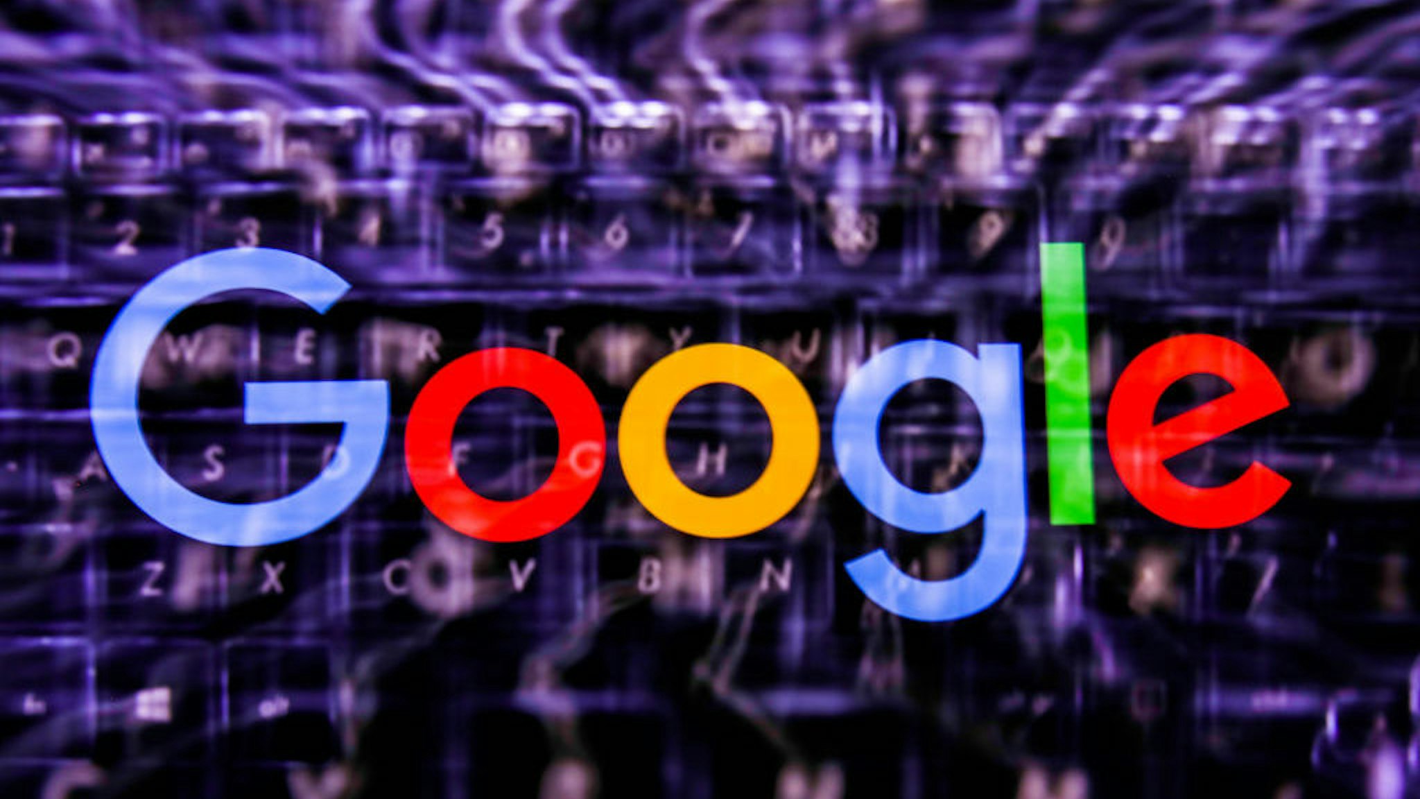 Google logo displayed on a phone screen and keyboard are seen in this multiple exposure illustration photo taken in Poland on June 14, 2020. European Commission officials said that Facebook, Twitter and Google should provide monthly fake news reports to prevent fake news about coronavirus pandemic. (Photo Illustration by Jakub Porzycki/NurPhoto via Getty Images)