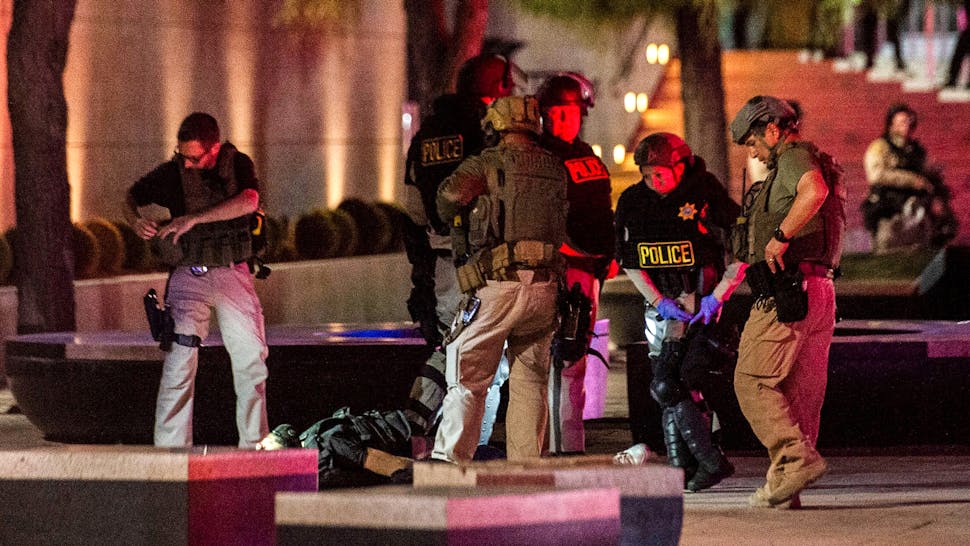 US-POLITICS-POLICE-JUSTICE-RACISM-DEMO Police officers surround a person that was shot near the 300 block of South Las Vegas Boulevard, on June 1, 2020, in downtown Las Vegas, at the end of a rally in response to the recent death of George Floyd, an unarmed black man who died while in police custody. - Thousands of National Guard troops patrolled major US cities after five consecutive nights of protests over racism and police brutality that boiled over into arson and looting, sending shock waves through the country. The death Monday of an unarmed black man, George Floyd, at the hands of police in Minneapolis ignited this latest wave of outrage in the US over law enforcement's repeated use of lethal force against African Americans -- this one like others before captured on cellphone video.