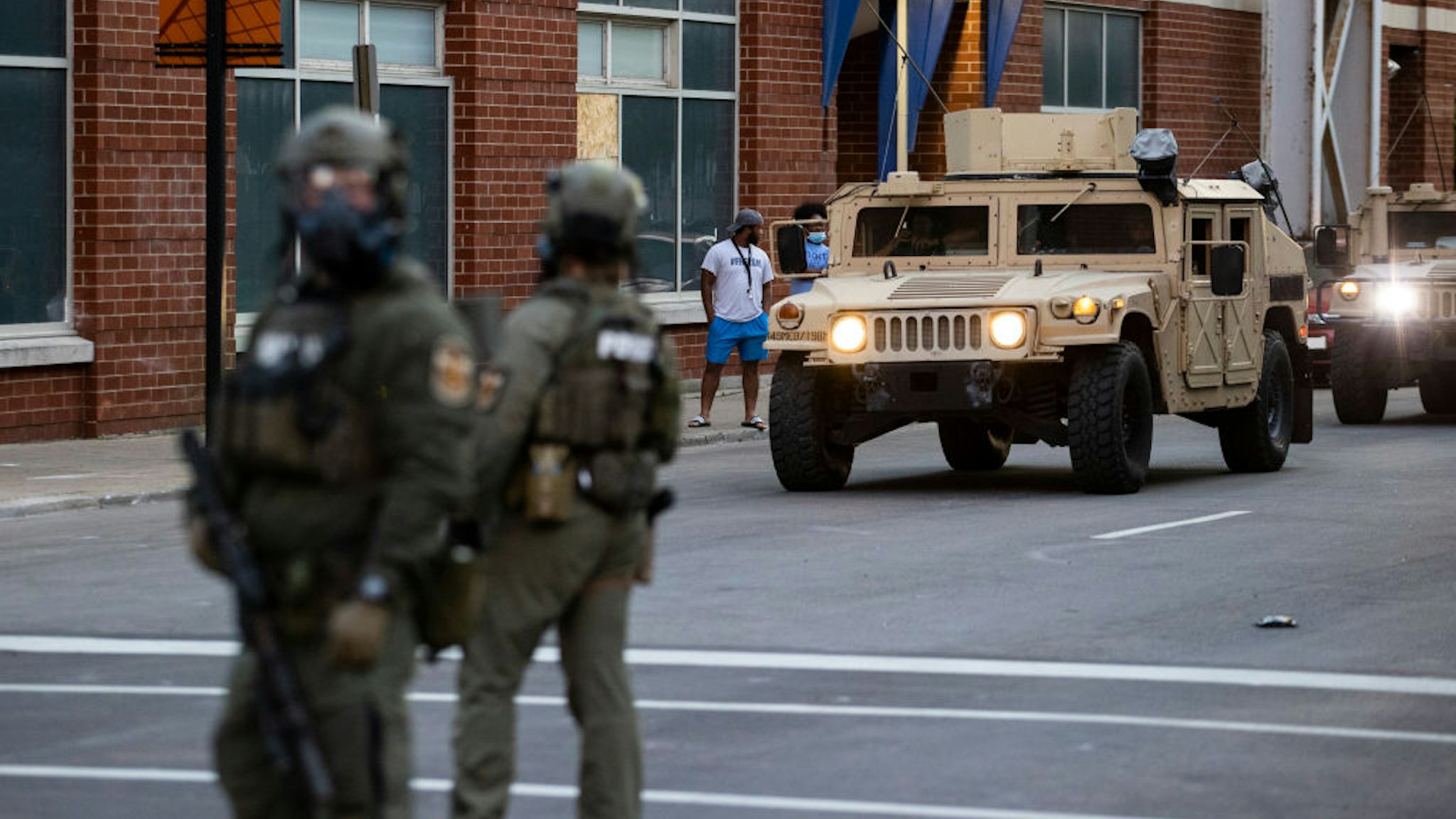 LOUISVILLE, KY - MAY 30: National Guard vehicles drive into downtown behind police officers in riot gear as protests occur on May 30, 2020 in Louisville, Kentucky. Protests have erupted after recent police-related incidents resulting in the deaths of African-Americans Breonna Taylor in Louisville and George Floyd in Minneapolis, Minnesota. (Photo by Brett Carlsen/Getty Images)