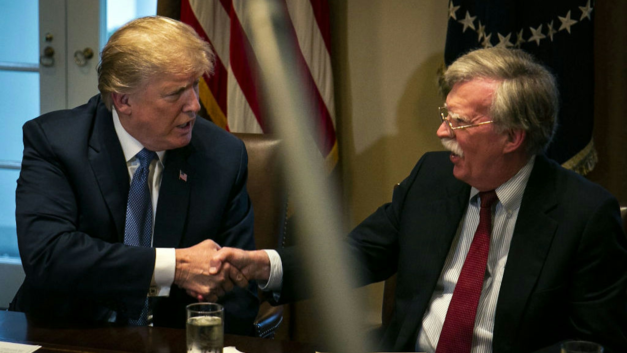 U.S. President Donald Trump, left, shakes hands with John Bolton, national security advisor, during a meeting with senior military leadership in the Cabinet Room of the White House in Washington, D.C., U.S., on Monday, April 9, 2018. Trump said he'll decide within two days on U.S. retaliation against Syria for a suspected chemical weapons attack by President Bashar al-Assad's regime over the weekend, and suggested Russian President Vladimir Putin may share responsibility. Photographer: Al Drago/Bloomberg