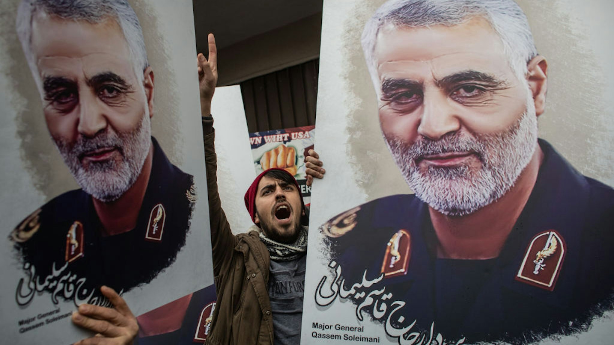 ISTANBUL, TURKEY - JANUARY 05: People hold posters showing the portrait of Iranian Revolutionary Guard Major General Qassem Soleimani and chant slogans during a protest outside the U.S. Consulate on January 05, 2020 in Istanbul, Turkey. Major General Qassem Soleimani, was killed by a U.S. drone strike outside the Baghdad Airport on January 3. Since the incident, tensions have risen across the Middle East. (Photo by Chris McGrath/Getty Images)