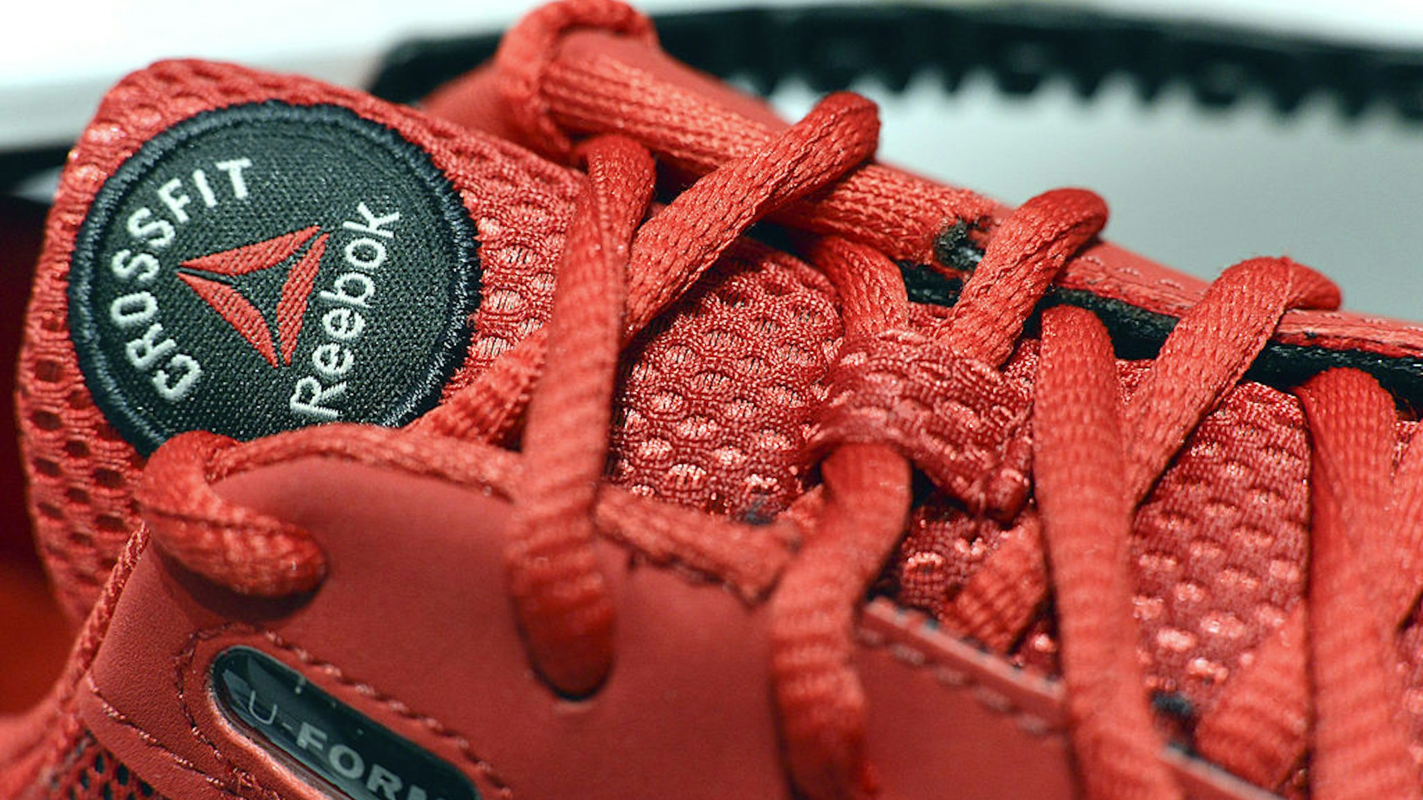 Reebok CrossFit footwear is seen on display during the Adidas AG earnings news conference in Herzogenaurach, Germany, on Thursday, March 7, 2013. Adidas AG, the world's second- largest sporting-goods maker, forecast higher sales and profit this year and raised its dividend by 35 percent as it targets fast-growing emerging markets and introduces new products. Photographer: Guenter Schiffmann/Bloomberg