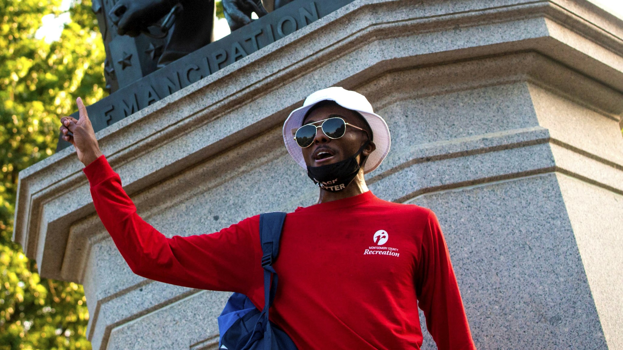 A protest leader speaks during a rally in support for the removal of the Emancipation Statue at Lincoln Park in Washington, DC on June 23, 2020. - As the wave of anti-racism protests rocking the United States brings down monuments to figures linked to the country's history of slavery, the spotlight is shifting to other prominent people long considered untouchable.