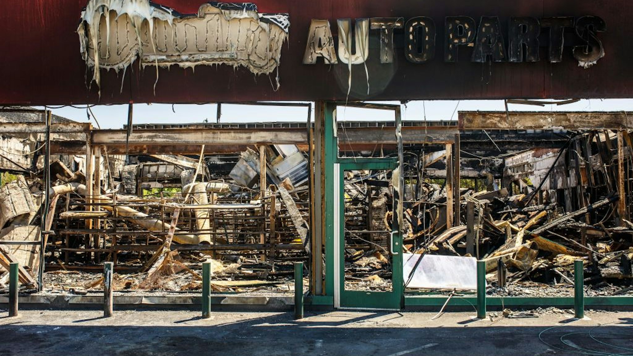 The charred wreckage of an Auto Parts store destroyed during last week's rioting which was sparked by the death of George Floyd on June 3, 2020 in Minneapolis, Minnesota. - Former Minneapolis police officer Derek Chauvin, who kneeled on the neck of George Floyd who later died, will now be charged with second-degree murder, and his three colleagues will face charges of aiding and abetting second-degree murder, court documents revealed on June 3. (Photo by Kerem Yucel / AFP) (Photo by KEREM YUCEL/AFP via Getty Images)