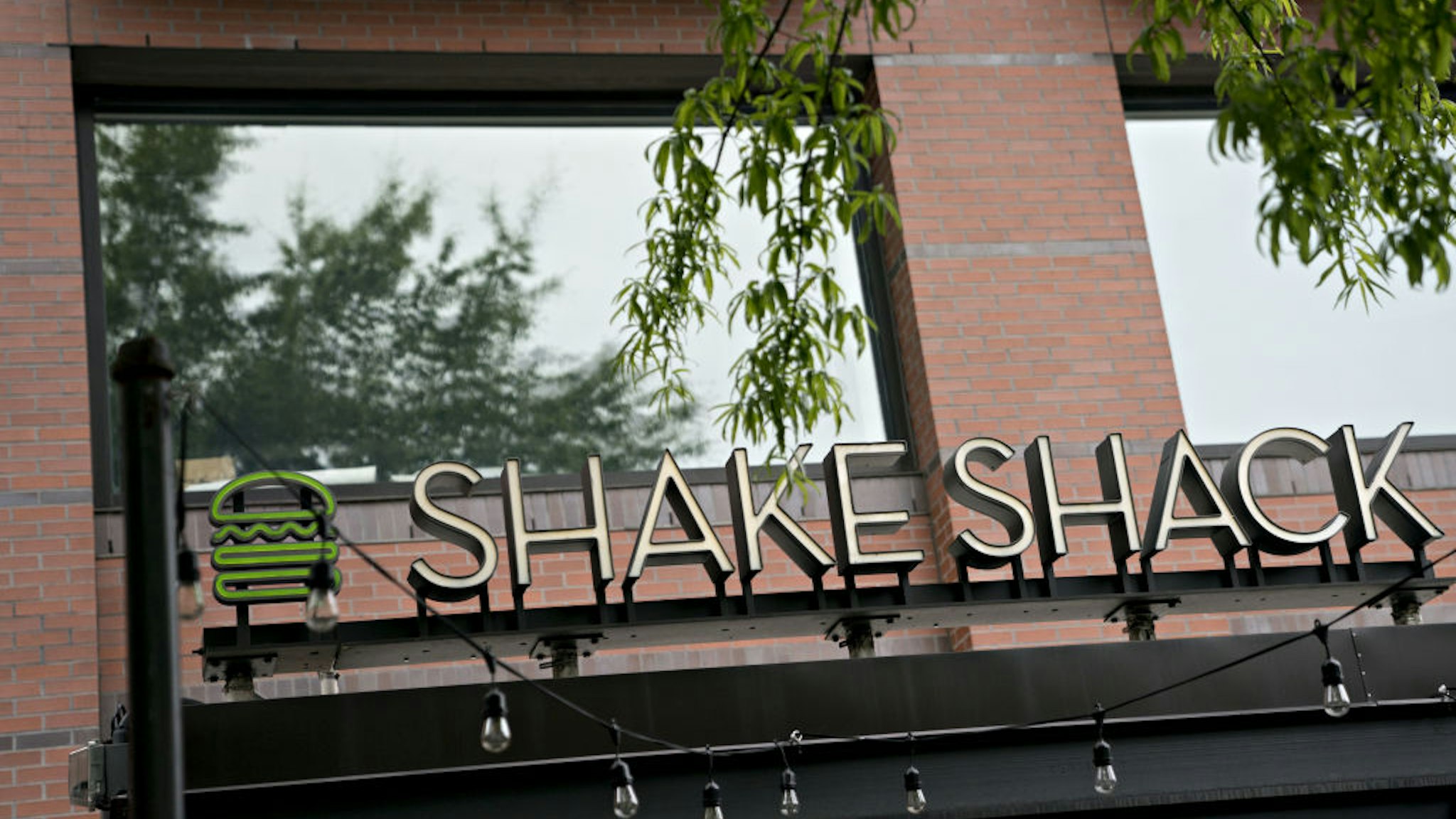 Signage stands at a Shake Shack restaurant in Washington, D.C., U.S., on Monday, April 20, 2020. Shake Shack Inc. will return a $10 million loan from the U.S. government amid criticism that the publicly traded burger chain and other larger companies gobbled up the emergency funding while smaller businesses were frozen out. Photographer: Andrew Harrer/Bloomberg via Getty Images