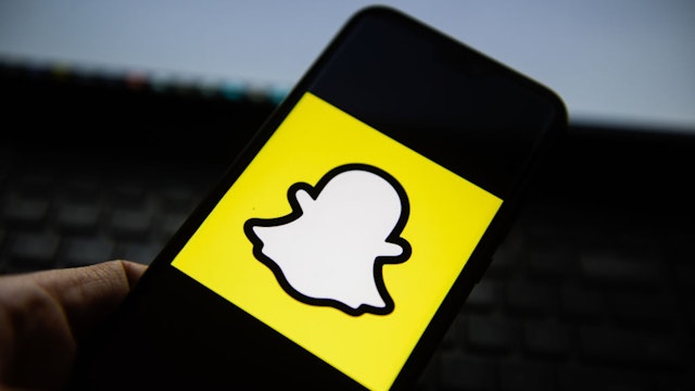 POLAND - 2019/11/22: In this photo illustration a Snapchat logo seen displayed on a smartphone.