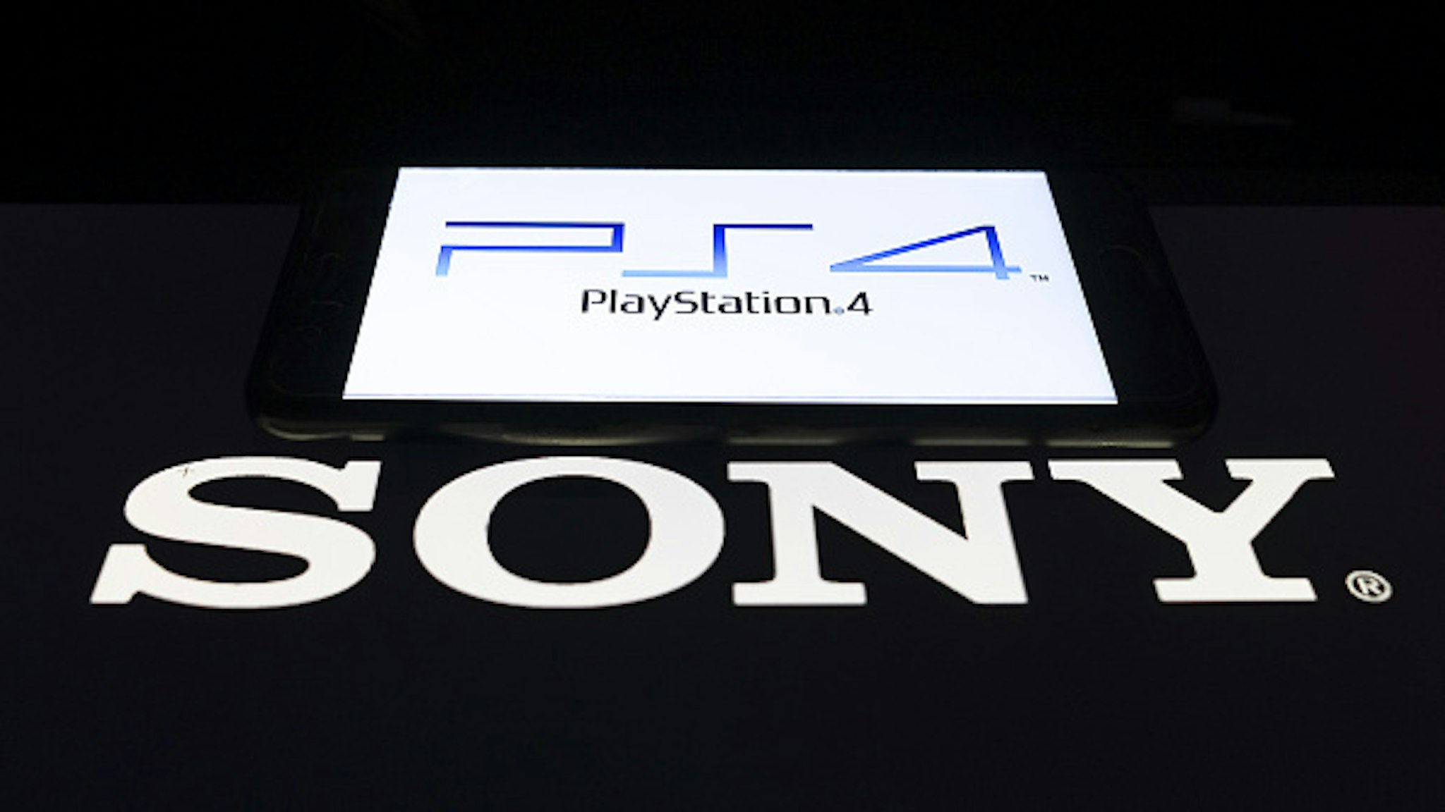 ANKARA, TURKEY - FEBRUARY 27: In this photo illustration a mobile phone and a computer screen display the PlayStation4 and Sony logo in Ankara Turkey on February 27, 2020.