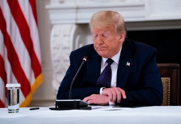 WASHINGTON, DC - JUNE 08: U.S. President Donald Trump pauses while making remarks as he participates in a roundtable with law enforcement officials in the State Dining Room of the White House, June, 8, 2020 in Washington, DC. From L-R is Attorney General William Barr, Daniel J, Cameron Attorney General for the Commonwealth of Kentucky, Trump.