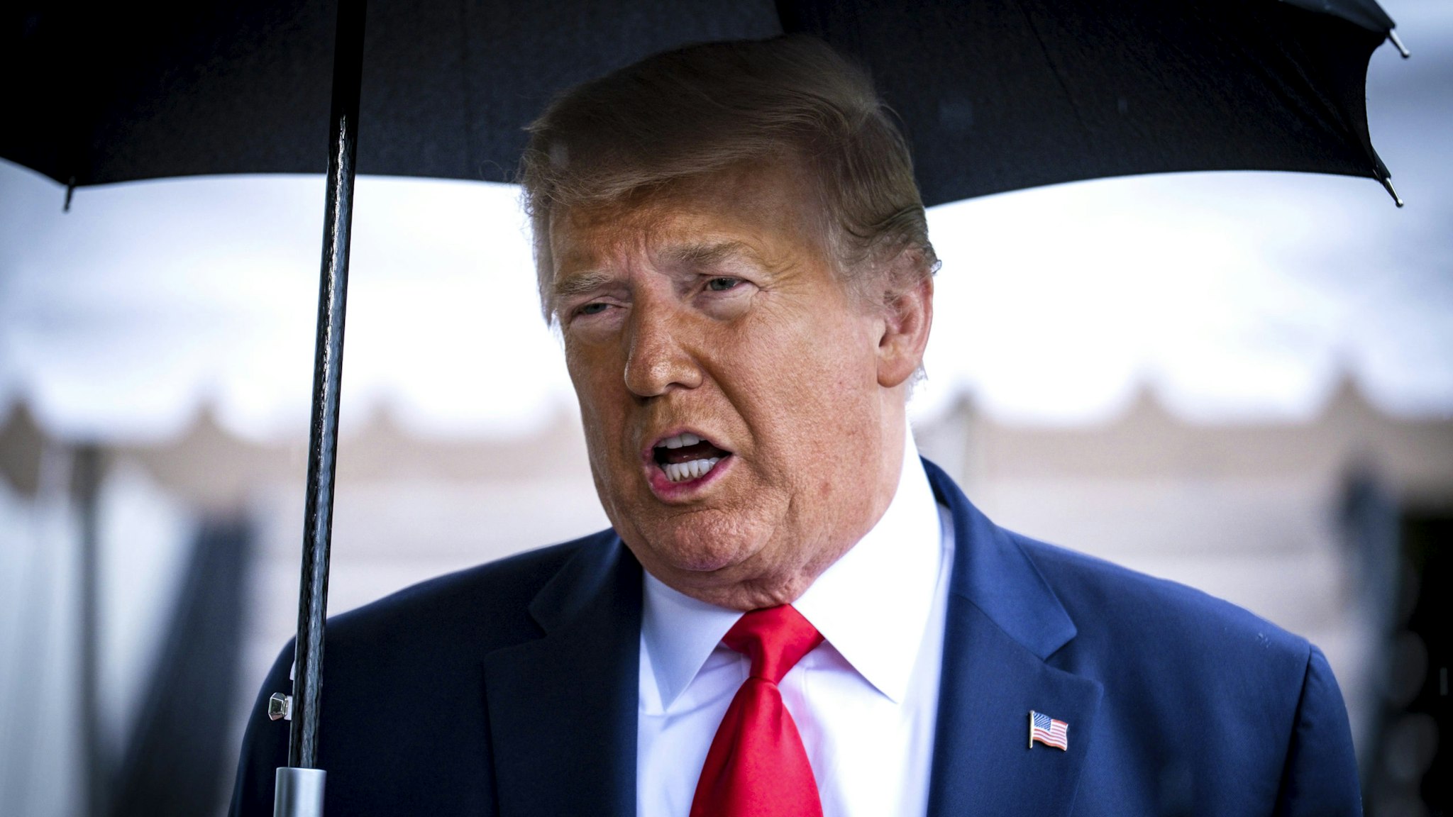 WASHINGTON, DC - JUNE 20:President Donald Trump stops to speak to the media in the rain on the South Lawn of the White House as he prepares to depart aboard Marine One for a rally in Tulsa, OK, on June 20, 2020 in Washington, DC. The rally is Trump's first in months since the coronavirus lockdown and his campaign acknowledged that six staff members had tested positive for the virus during routine screening.