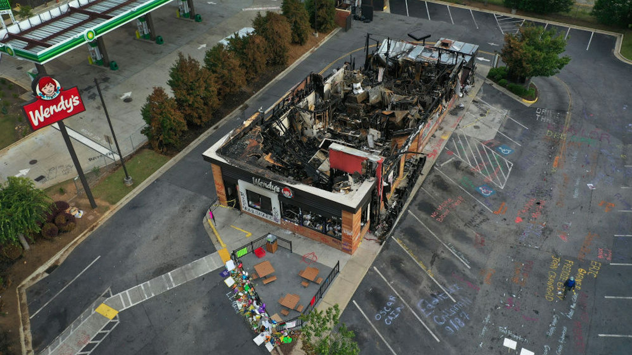 In this aerial photo, the Wendy's restaurant that was set on fire by demonstrators after Rayshard Brooks was killed is seen on June 17, 2020 in Atlanta, Georgia. The site has become a place of remembrance for Mr. Brooks, who was killed by police while fleeing after a struggle during a field sobriety test in the Wendy's parking lot. (Photo by Joe Raedle/Getty Images)