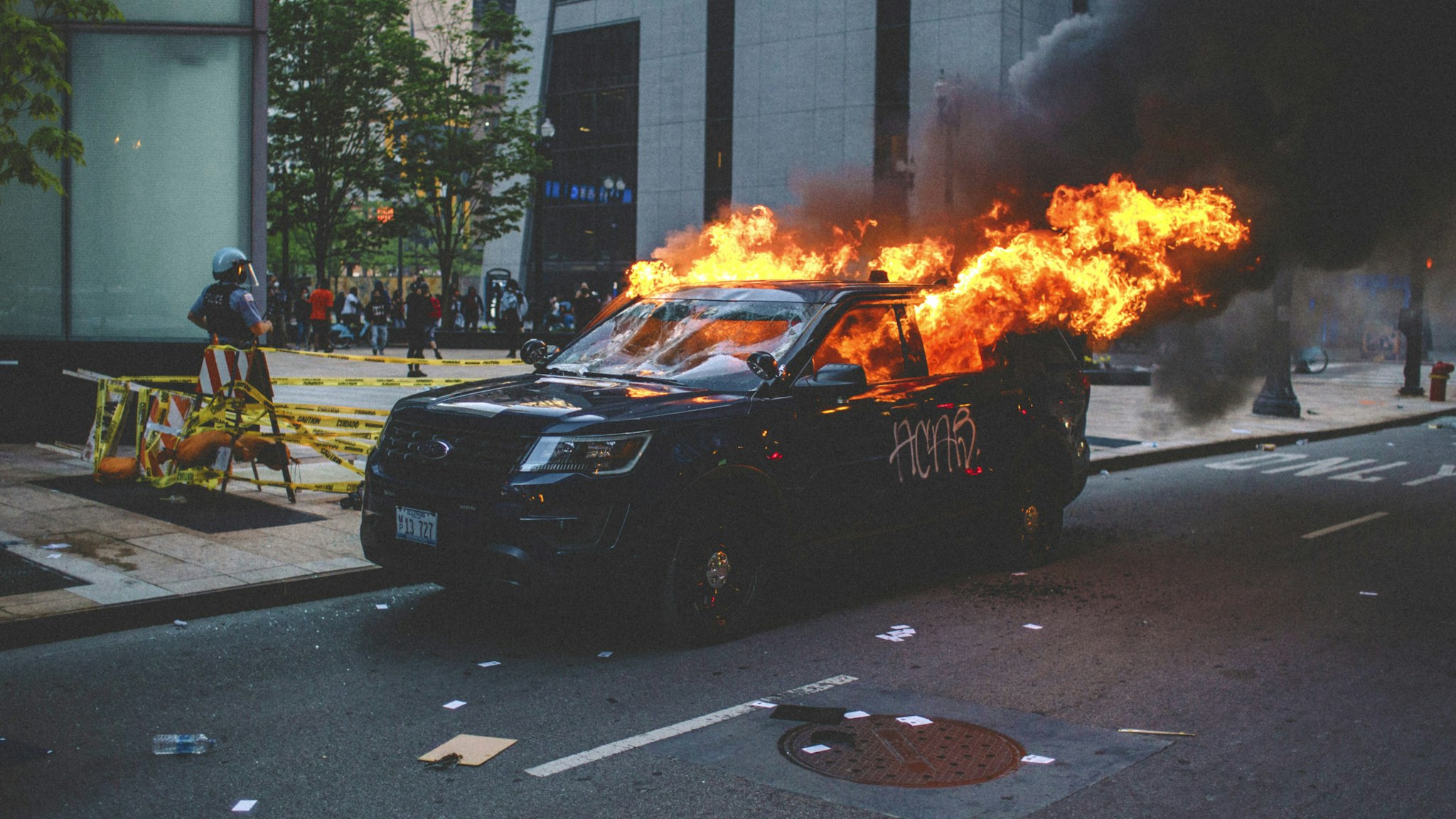 Protesters set fire to a police vehicle , on May 30, 2020 during a protest against the death of George Floyd, an unarmed black man who died while while being arrested and pinned to the ground by the knee of a Minneapolis police officer.